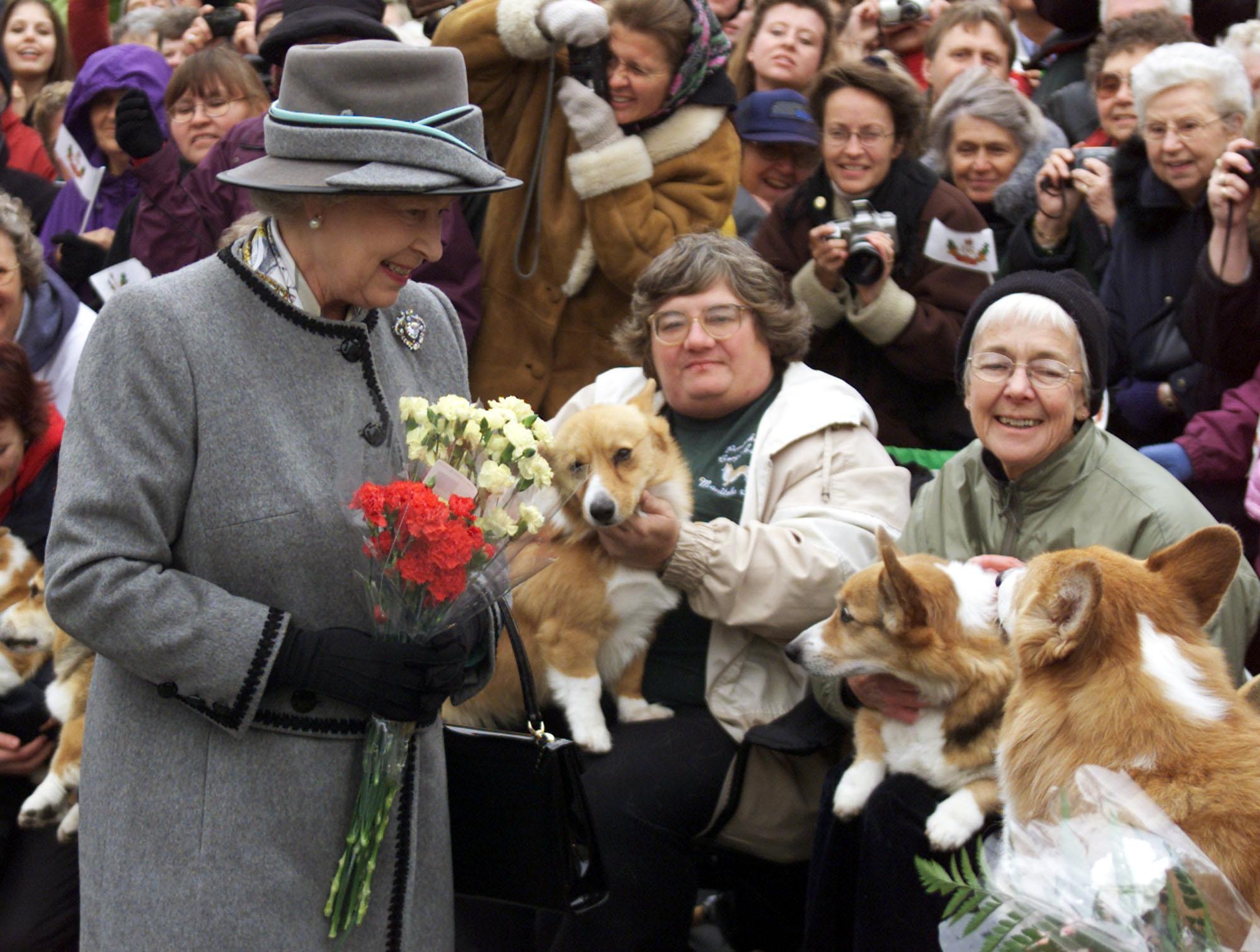 The Queen talks with members of the Manitoba Corgi Association during a visit to Canada in 2002