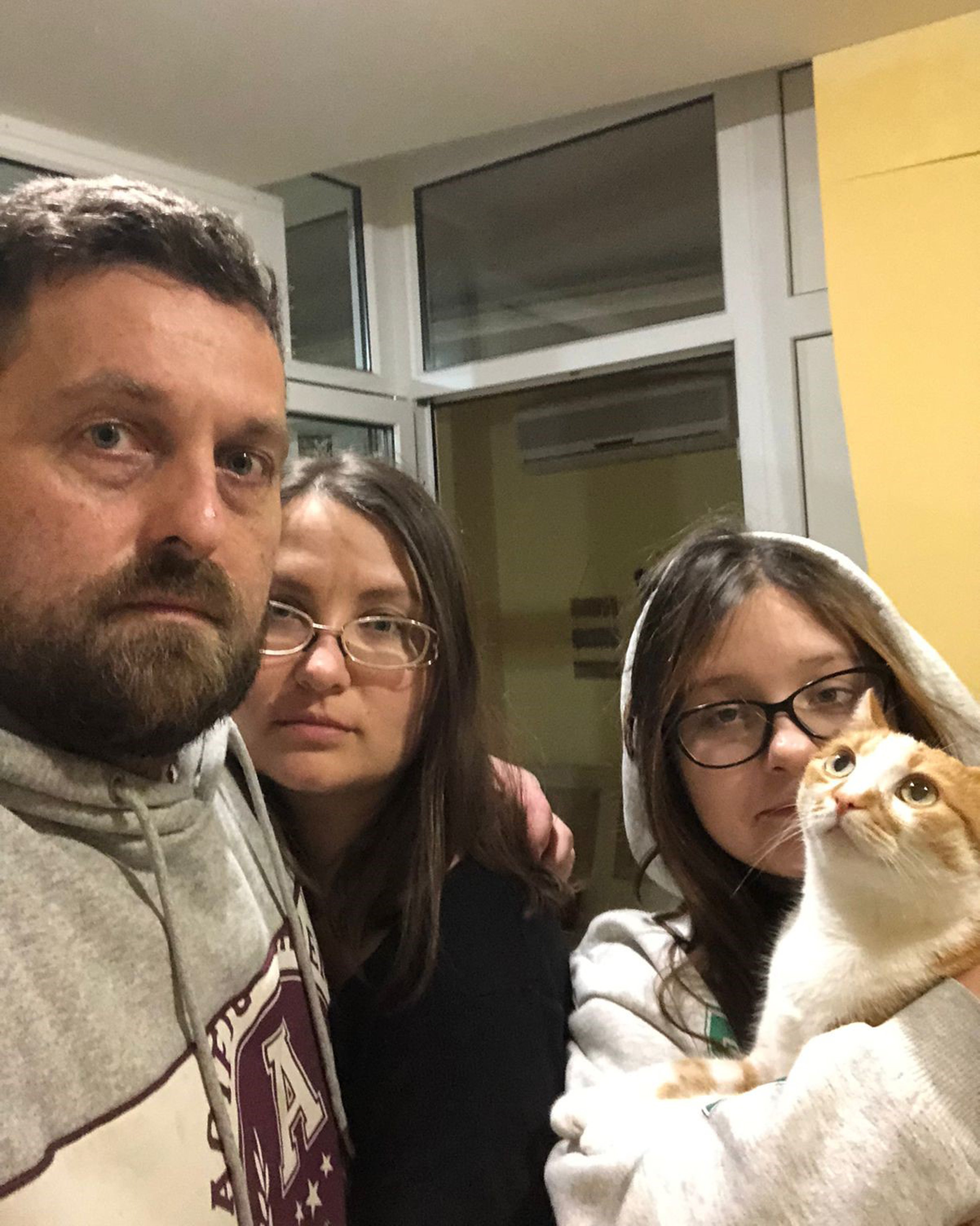 Dan Baker who has lived in Kyiv, for five years with his wife Victoria, stepdaughter Veronica, and Pumpkin the cat (Dan Baker/PA)