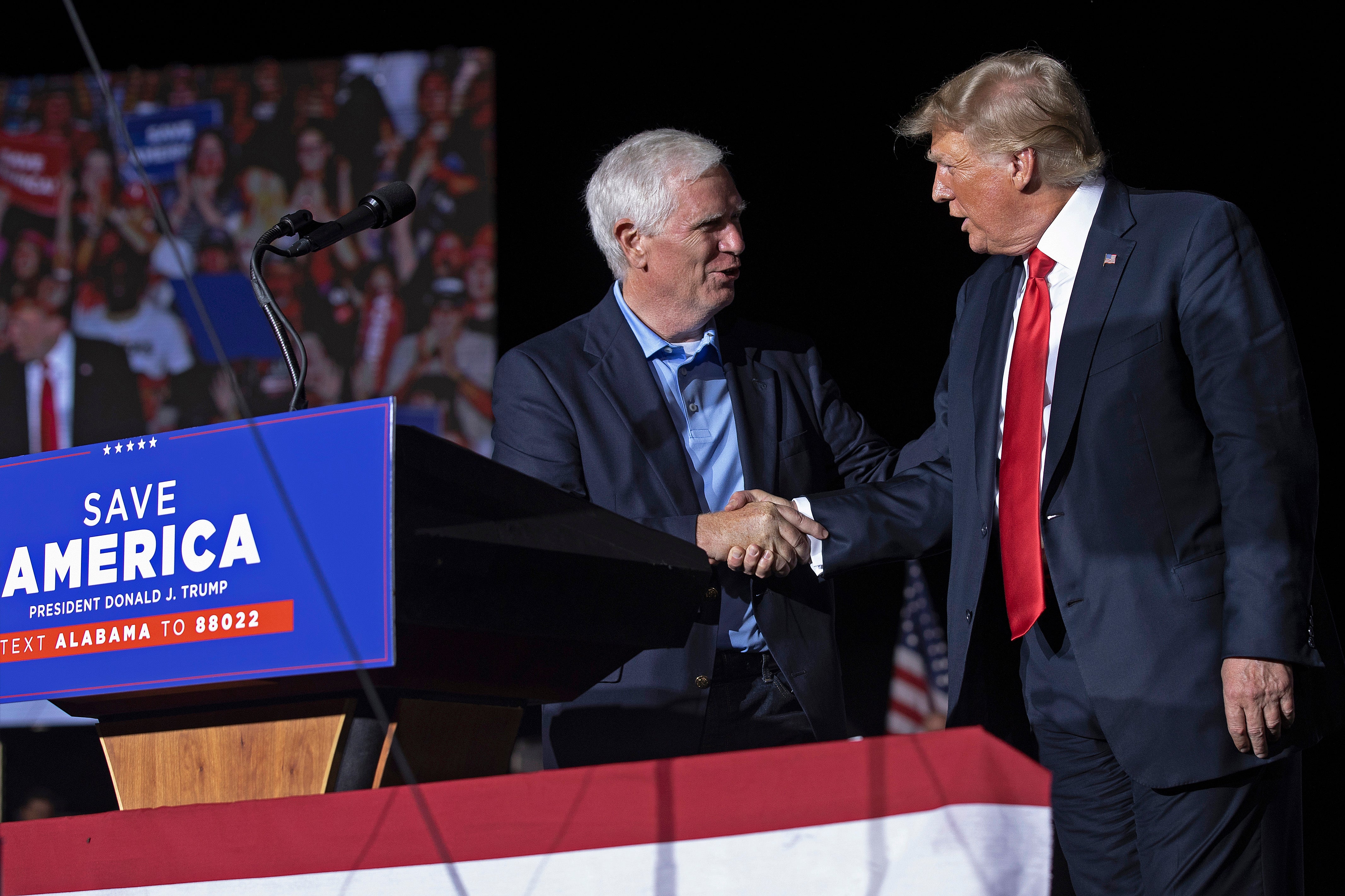 Former President Donald Trump welcomes candidate for US Senate Rep Mo Brooks to the stage during a "Save America" rally at York Family Farms on August 21, 2021 in Cullman, Alabama.