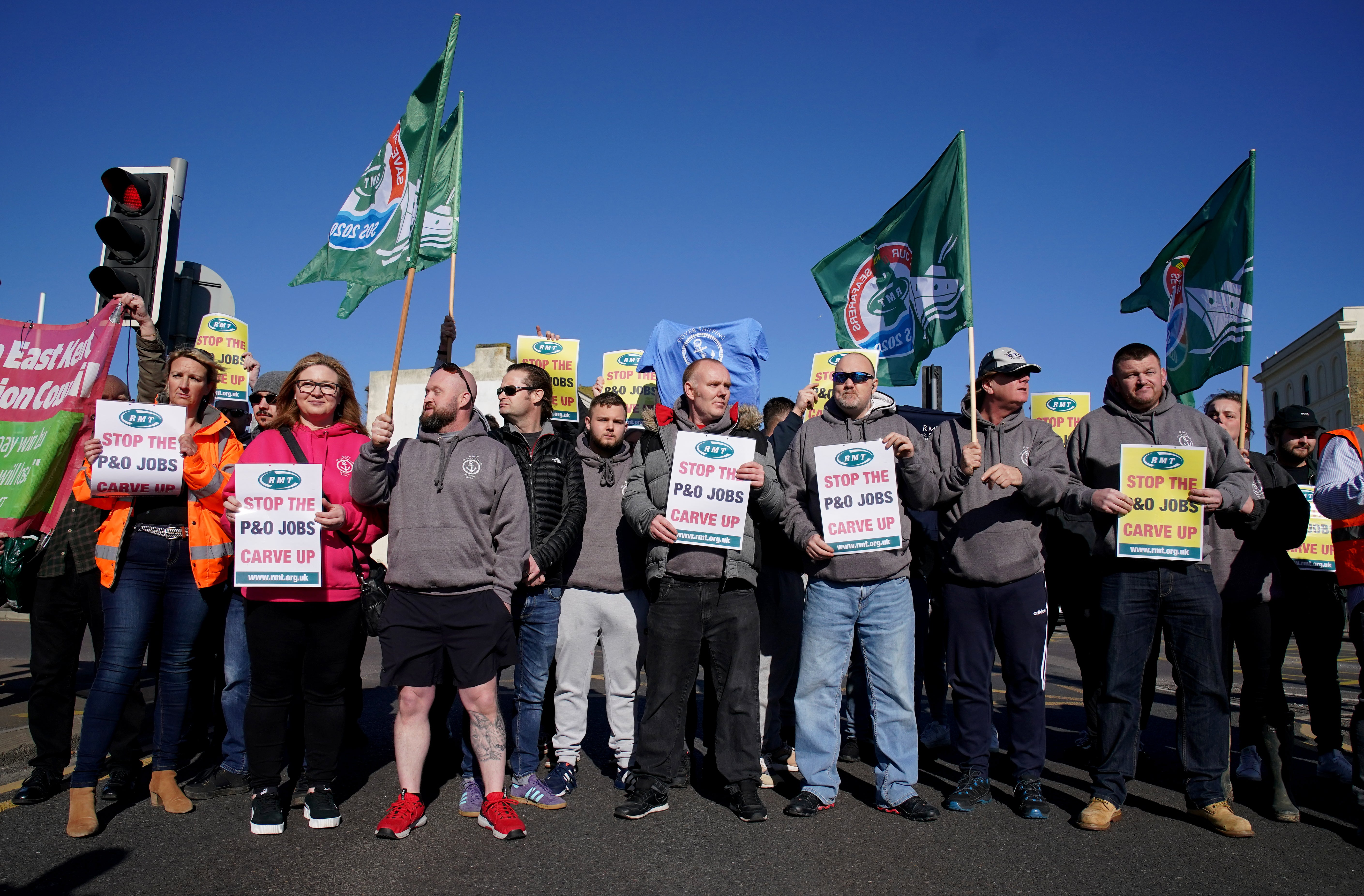 Former P&O staff and RMT members block the road leading to the Port of Dover as P&O Ferries suspended sailings and handed 800 seafarers immediate severance notices, saying: “Our survival is dependent on making swift and significant changes.” Picture date: Thursday March 17, 2022. (Gareth Fuller/PA)