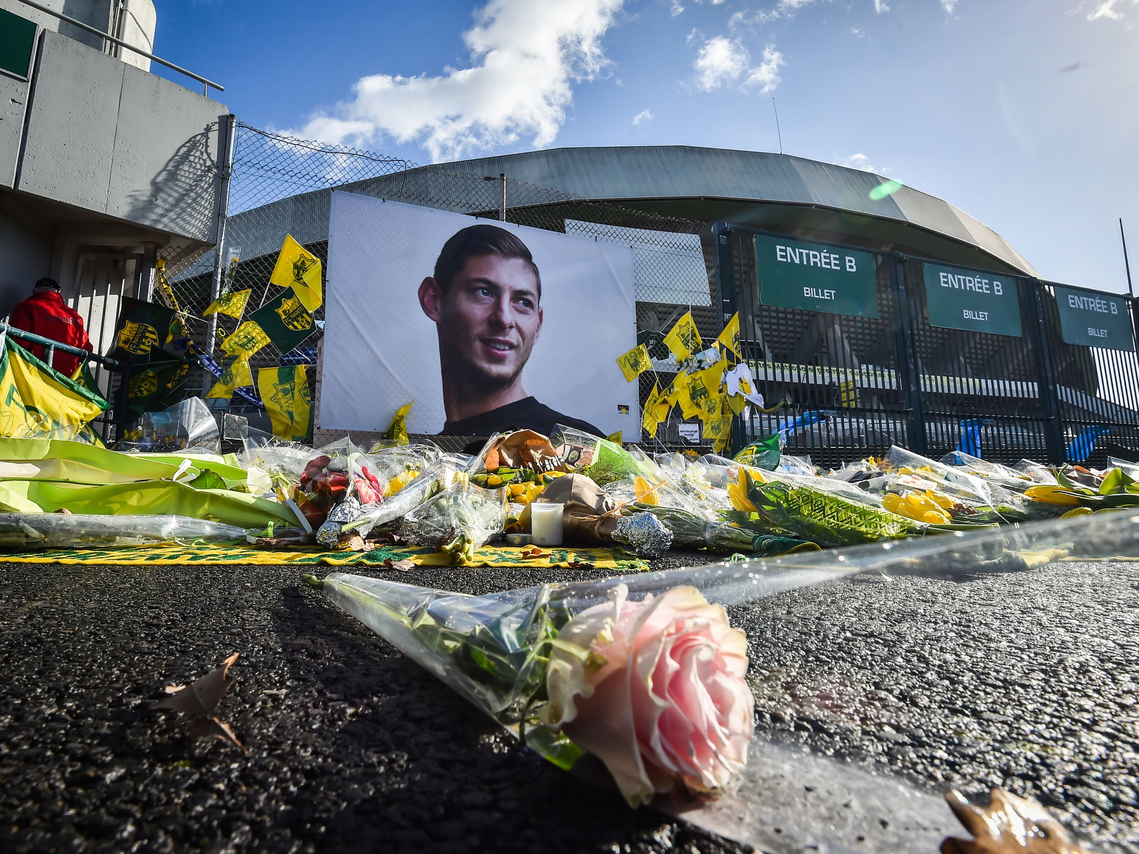 Flowers are displayed in front of the portrait of Argentinian forward Emiliano Sala at the Beaujoire stadium in Nantes a month after his death