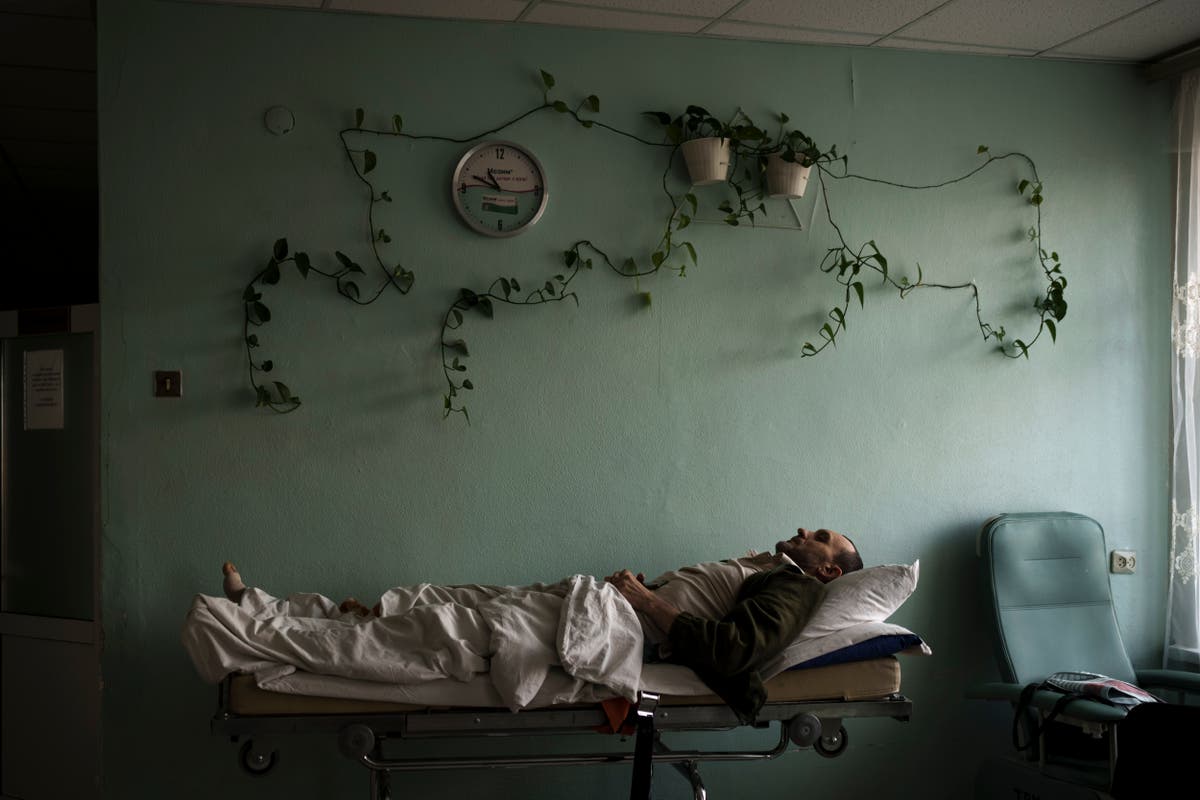 AP PHOTOS: Day 22: Buildings in flames, soldiers on guard AP PHOTOS: Day 22: Buildings in flames, soldiers on guard