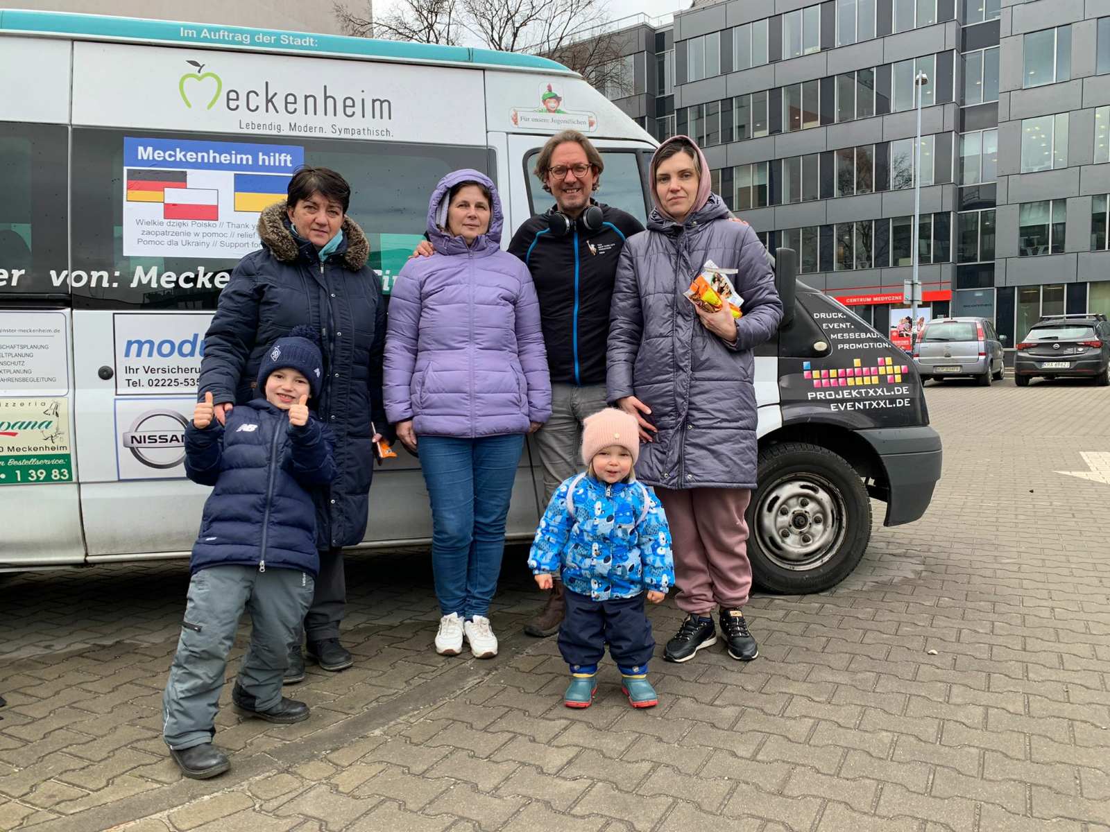 The mother of Andrii Zharikov, Tetyana Zharikova, 53, (middle) with family and friends next to a refugee bus taking her to safety from Ukraine (Family handout/PA Wire)
