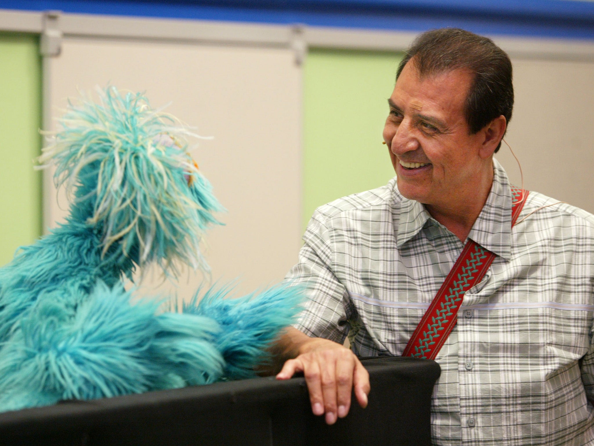 Luis and Rosita, a Muppet, chat during the introduction of the ‘You Can Ask!’ programme in 2003