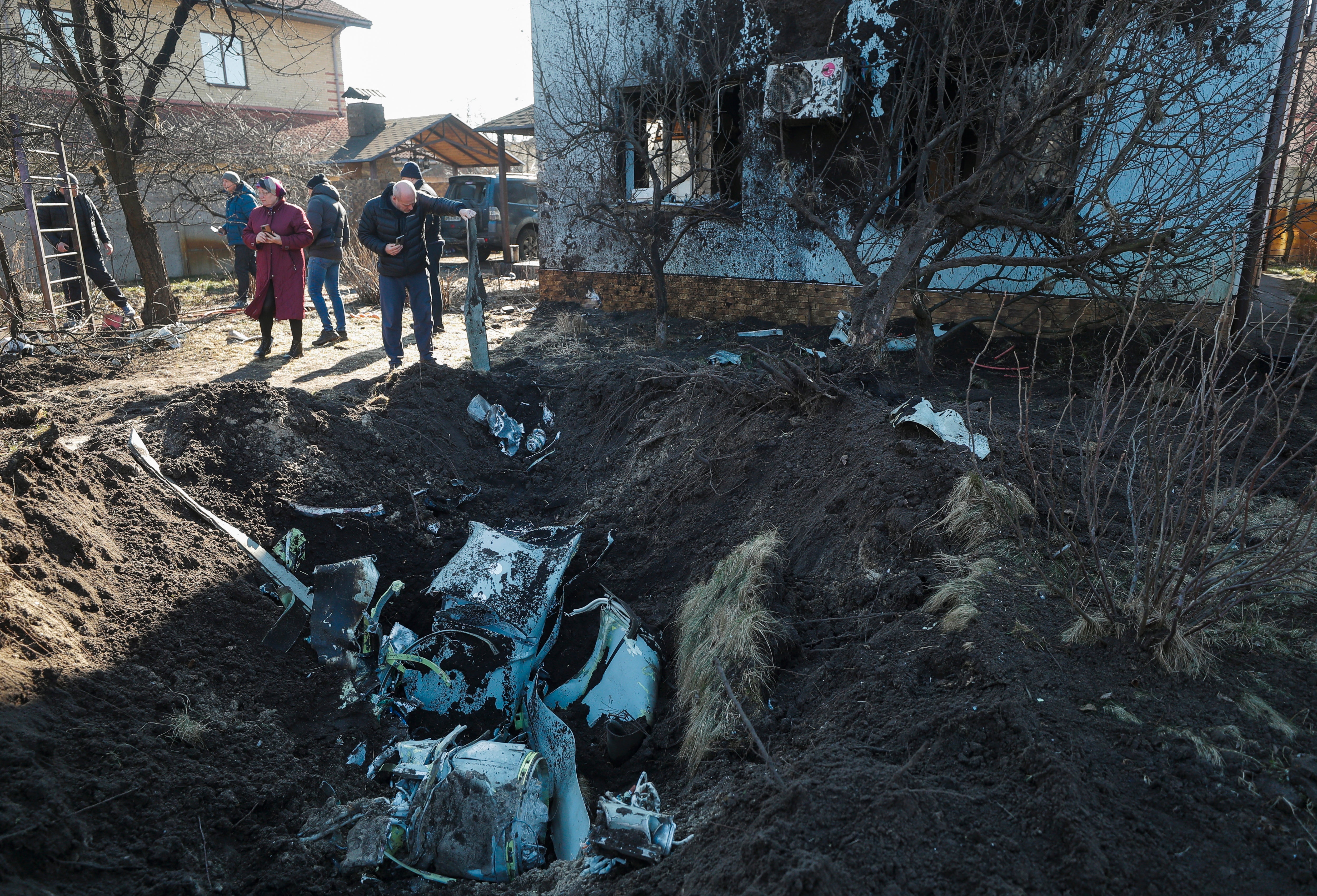 Debris of a rocket inside a shell crater following an overnight shelling on a village on the outskirts of Kyiv.