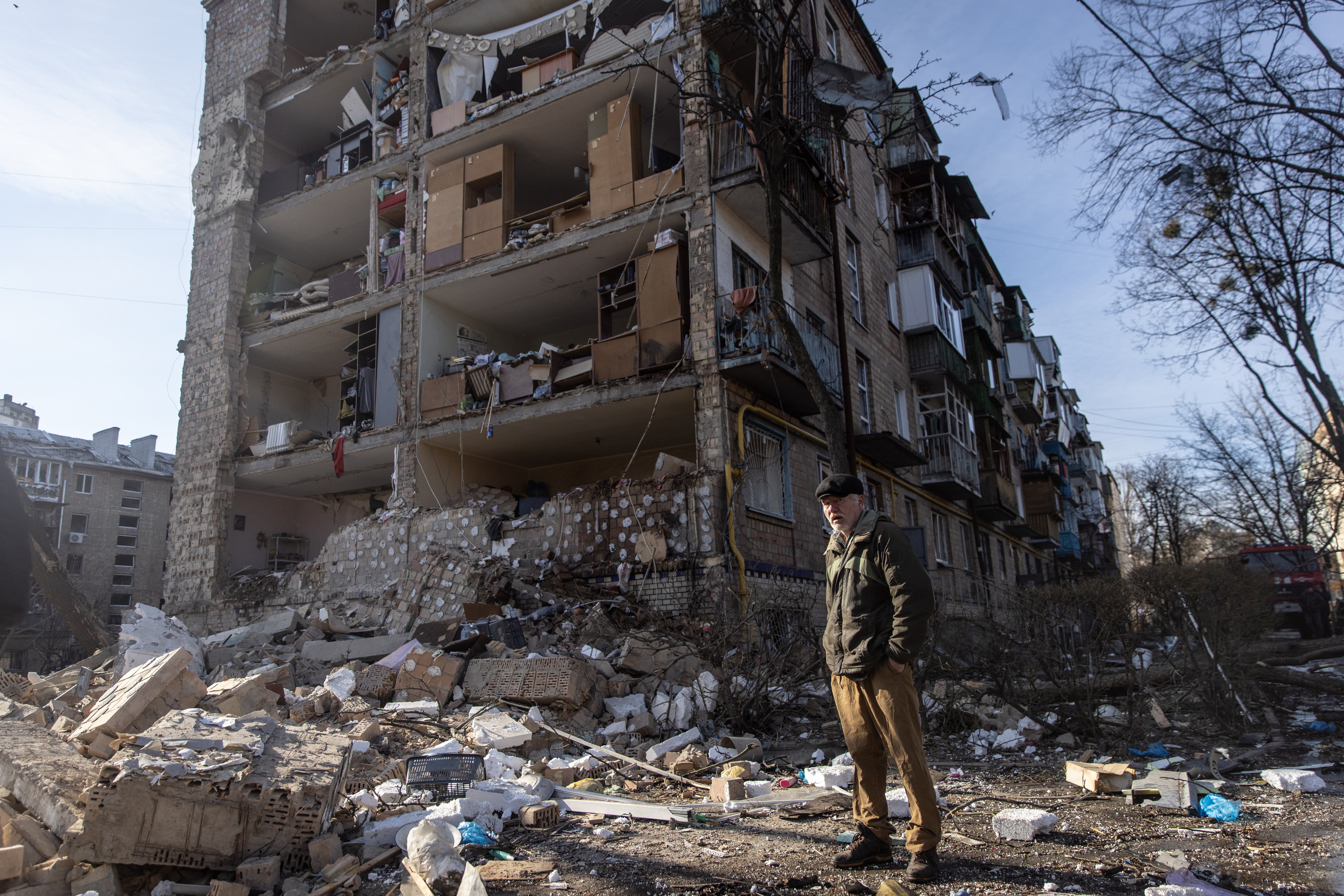 File photo: A man stands amid debris in front of a residential apartment complex that was heavily damaged by a Russian attack in Kyiv, Ukraine, 18 March 2022