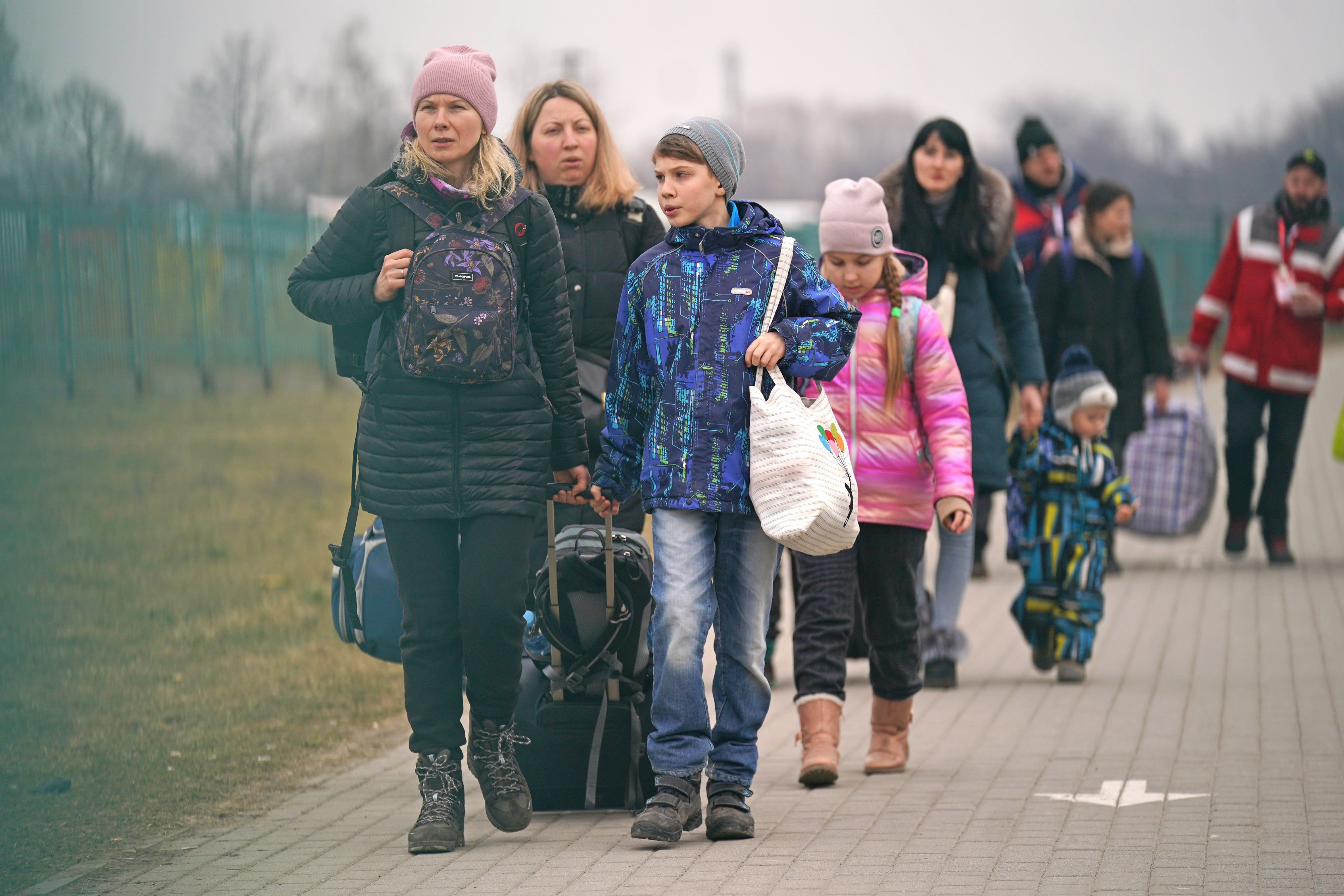 People crossing the border point from Ukraine into Medyka, Poland (Victoria Jones/PA)