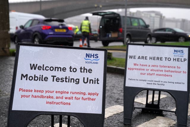 Signs at a mobile Covid-19 test site in Glasgow (Andrew Milligan/PA)