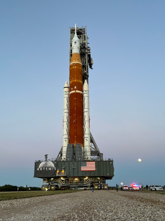 <p>Nasa’s new Moon rocket, the Space Launch System, rolls to the launchpad under moonlight. </p>