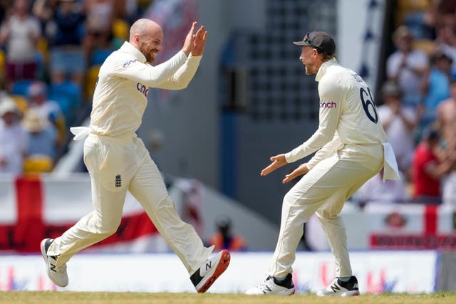 England’s Jack Leach celebrates with captain Joe Root the dismissal of West Indies’ Shamarh Brooks (Ricardo Mazalan/AP)
