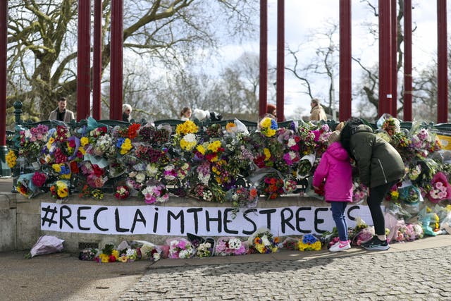 People leave floral tributes at the band stand in Clapham Common (Steve Parsons/PA)