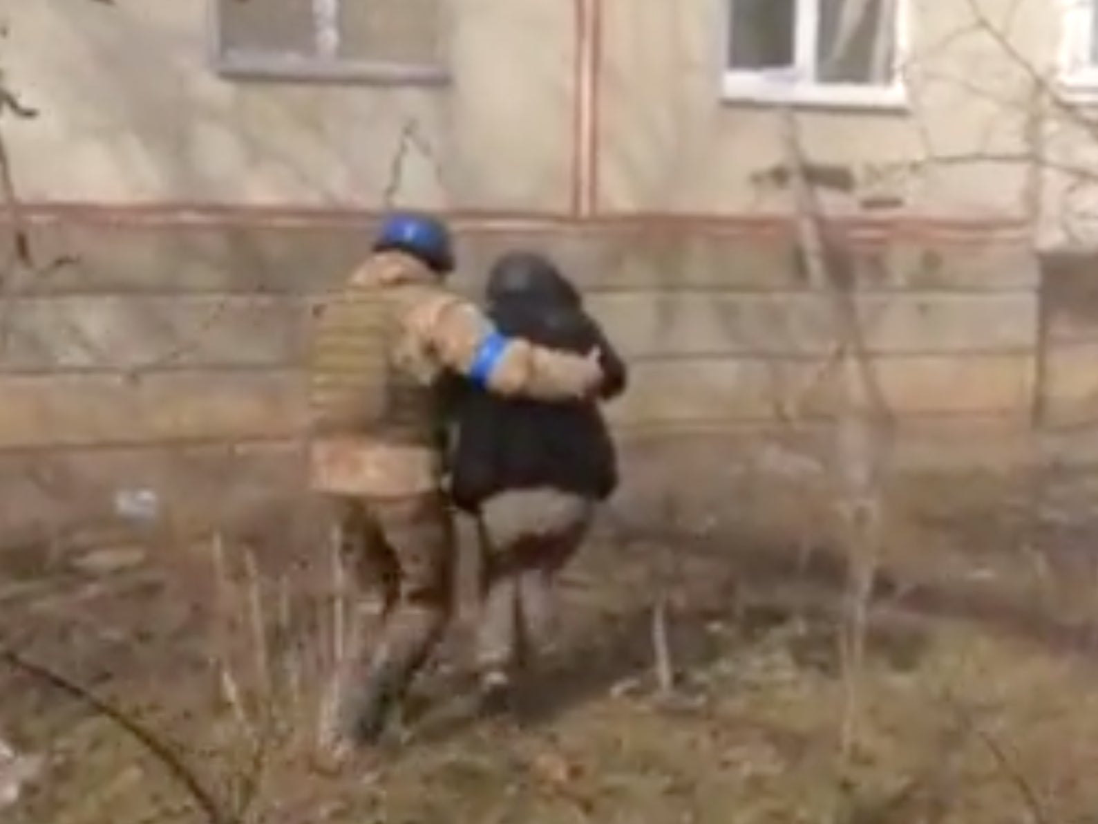 A Ukrainian army guide helps a member of the BBC crew into the temporary shelter
