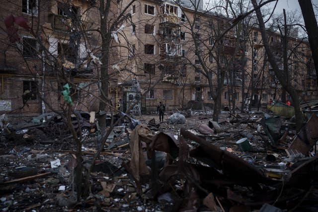 <p>A police officer walks at the site of a bombing that damaged residential buildings in Kyiv</p>