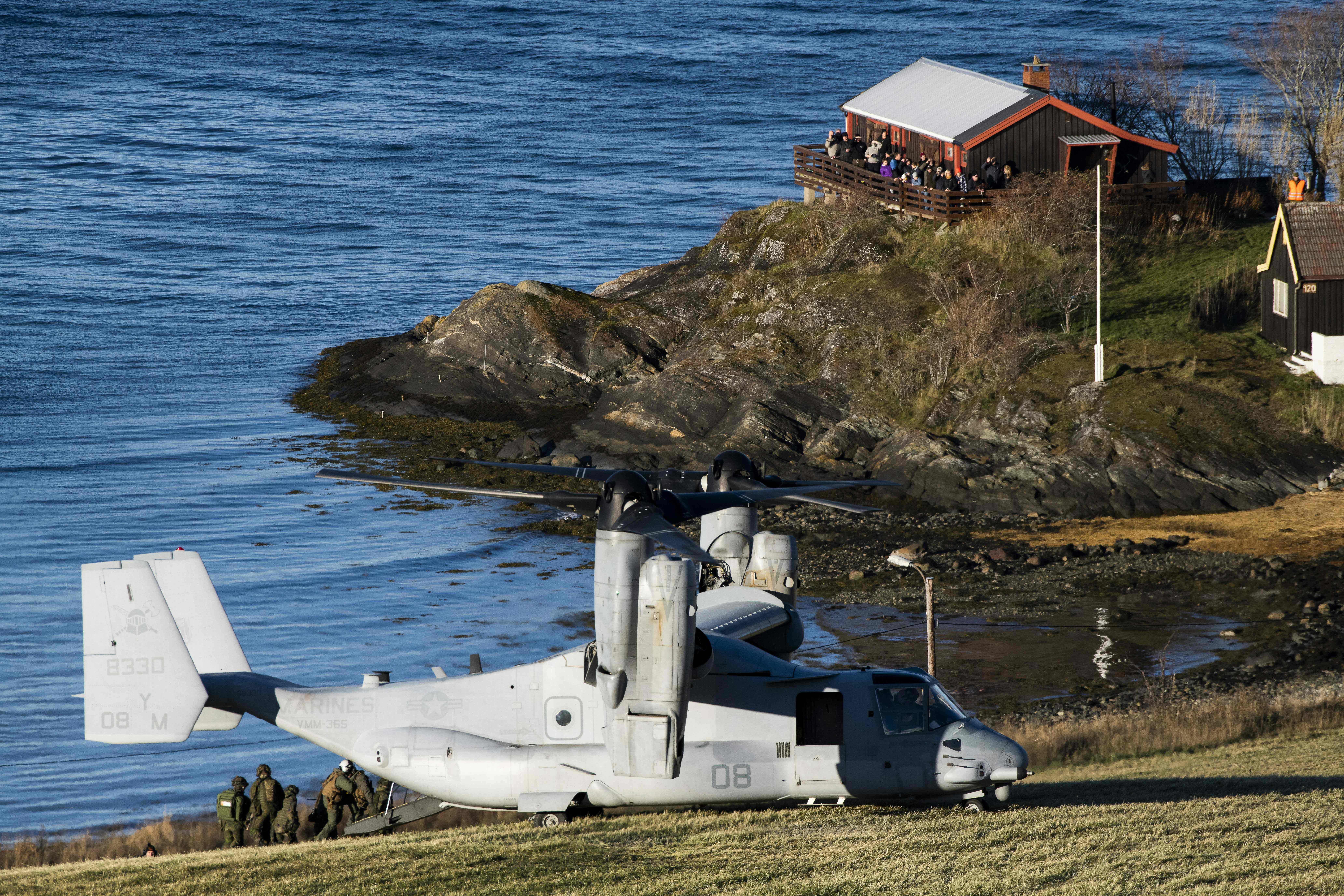 A United States' V-22 Osprey, a multi-mission, tiltrotor military aircraft with both vertical takeoff and landing, lands to pick up Marines during a joint demonstration as part of the NATO Trident Juncture 2018 exercise in Byneset near Trondheim, Norway, October 30, 2018.