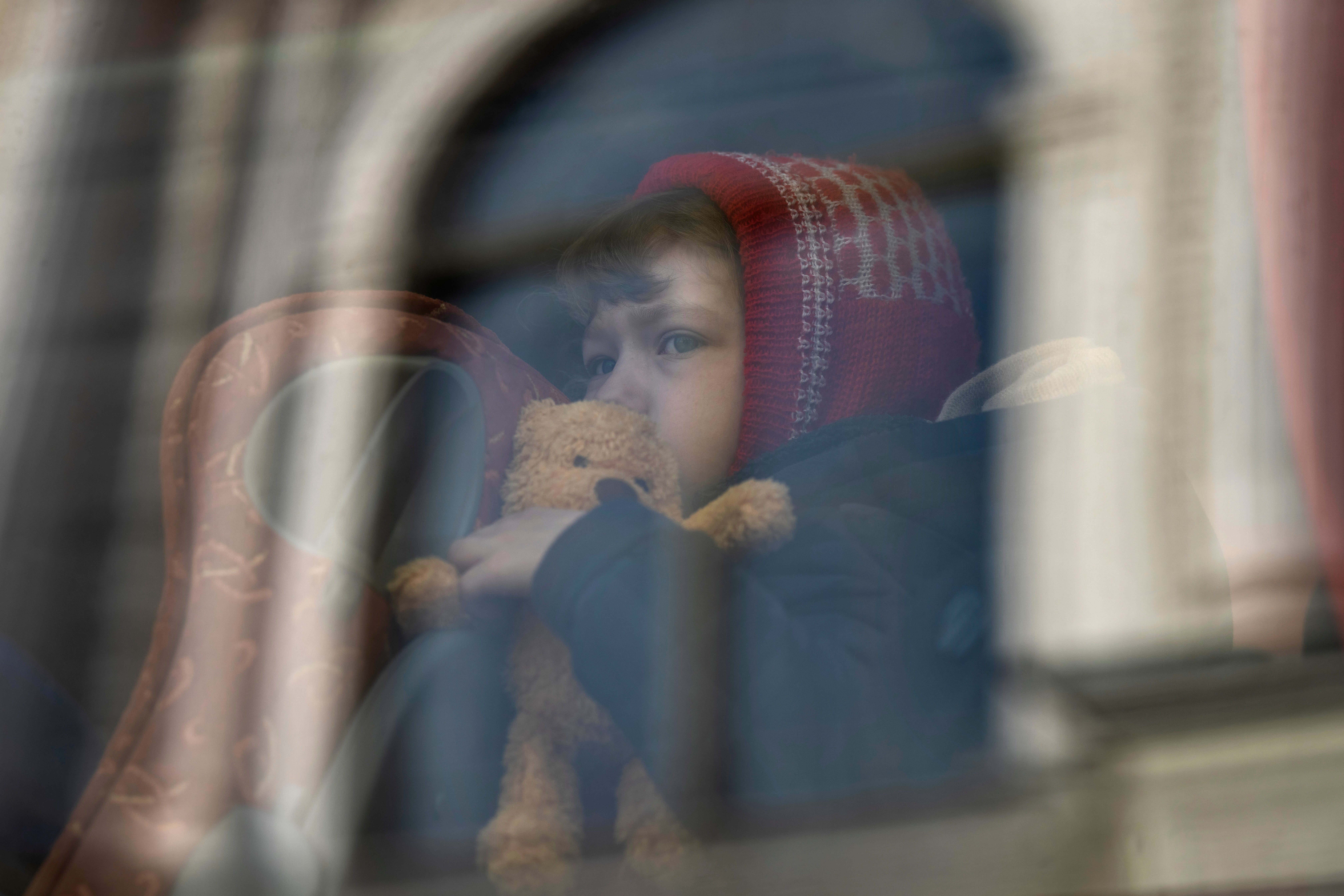 A child who fled the war in Ukraine waits in a bus after arriving in Poland (Petros Giannakouris/AP)