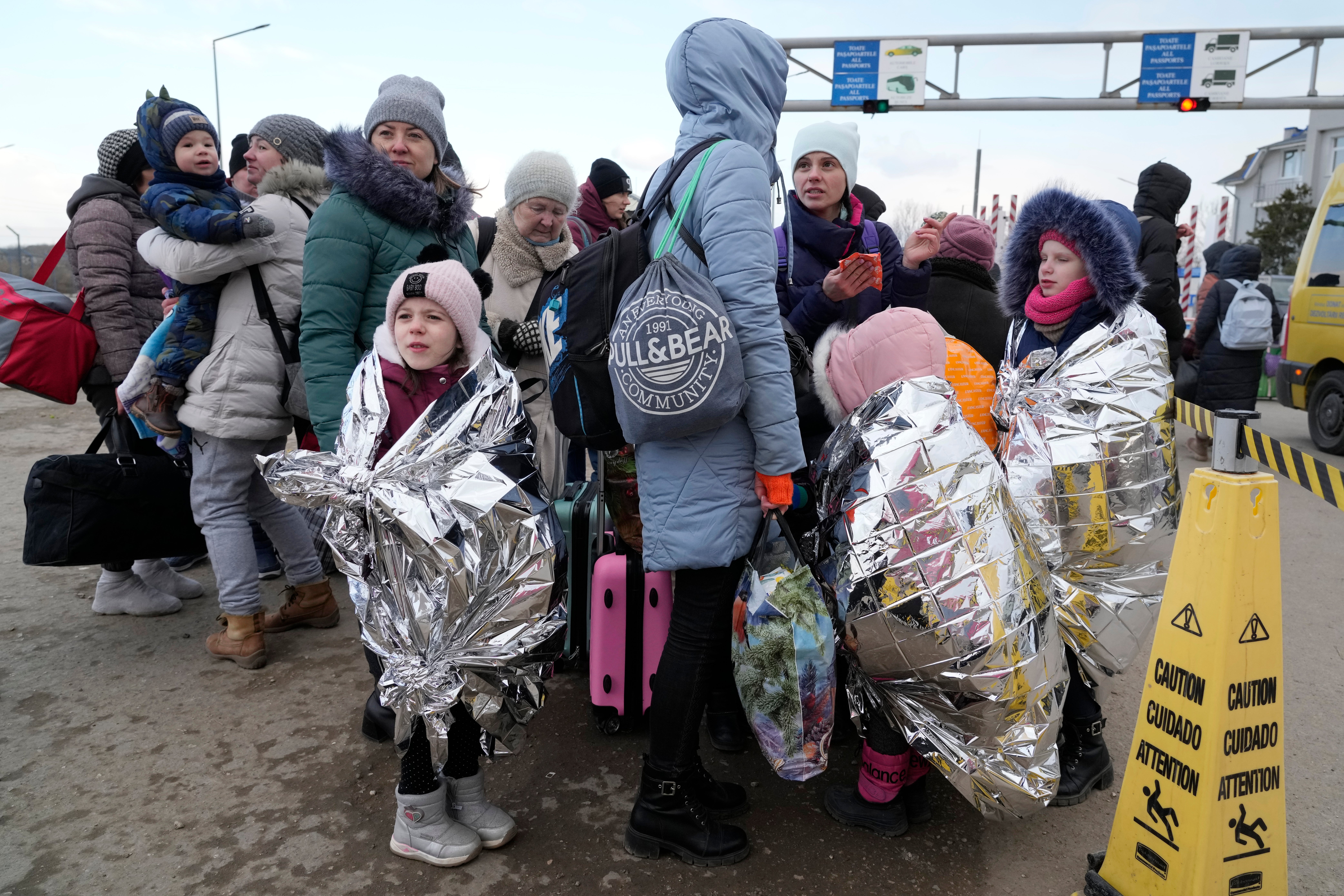 Refugees who fled neighbouring Ukraine at the border crossing in Palanca, Moldova (Sergei Grits/AP)