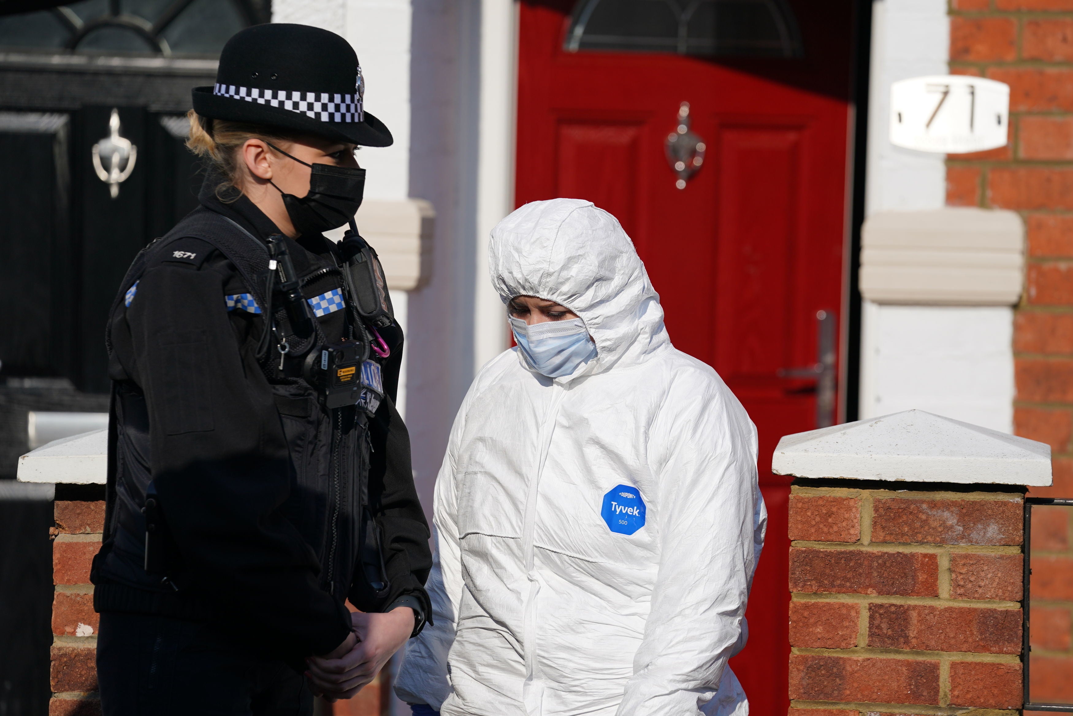 Forensic officers in Moore Street, Kingsley, Northampton after the discovery of a body in the garden