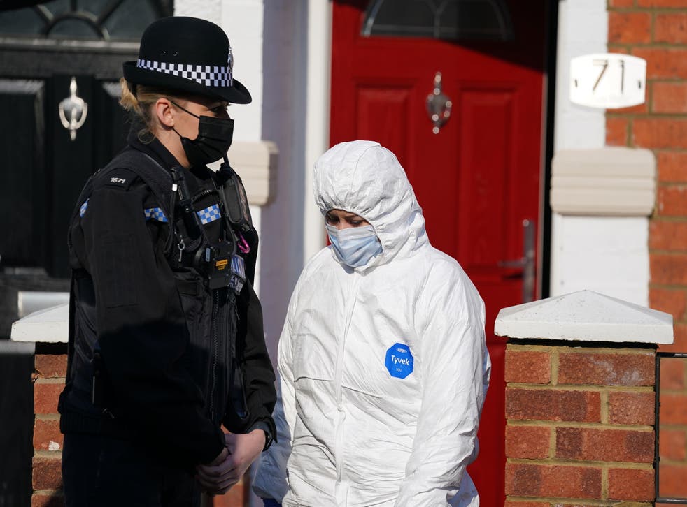 <p>Forensic officers in Moore Street, Kingsley, Northampton after the discovery of a body in the garden</p>