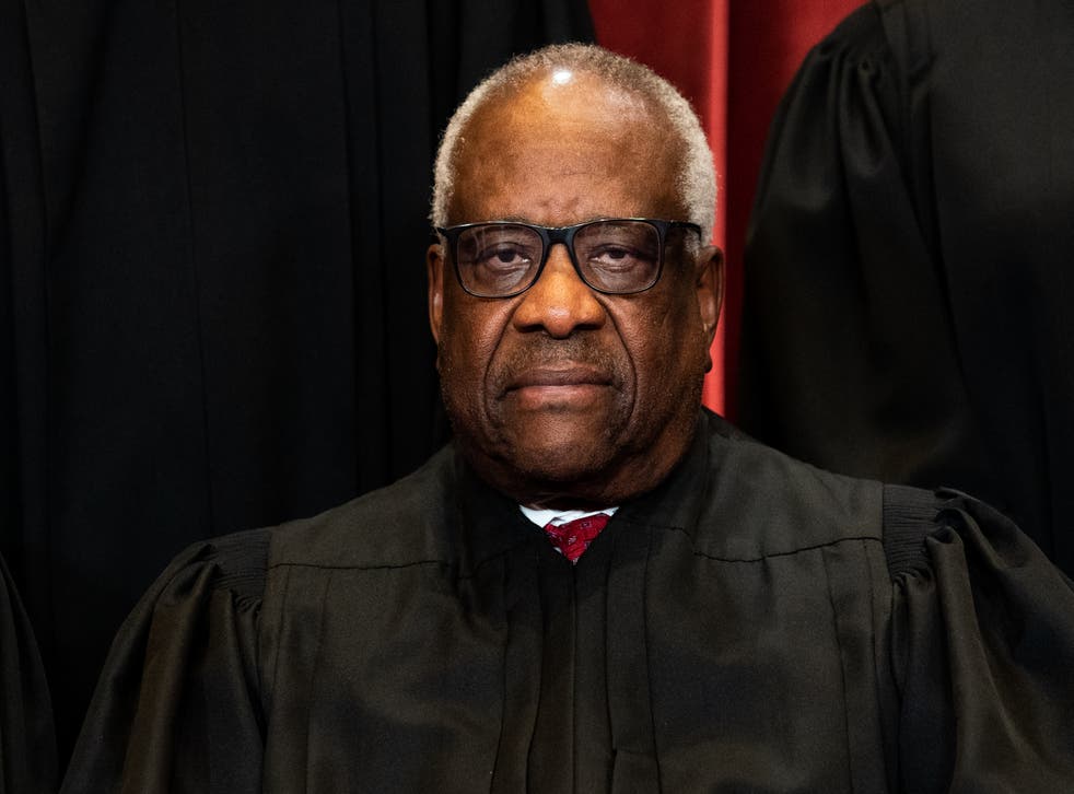 <p>Associate Justice Clarence Thomas sits during a group photo of the Justices at the Supreme Court in Washington, DC on April 23, 2021. </p>