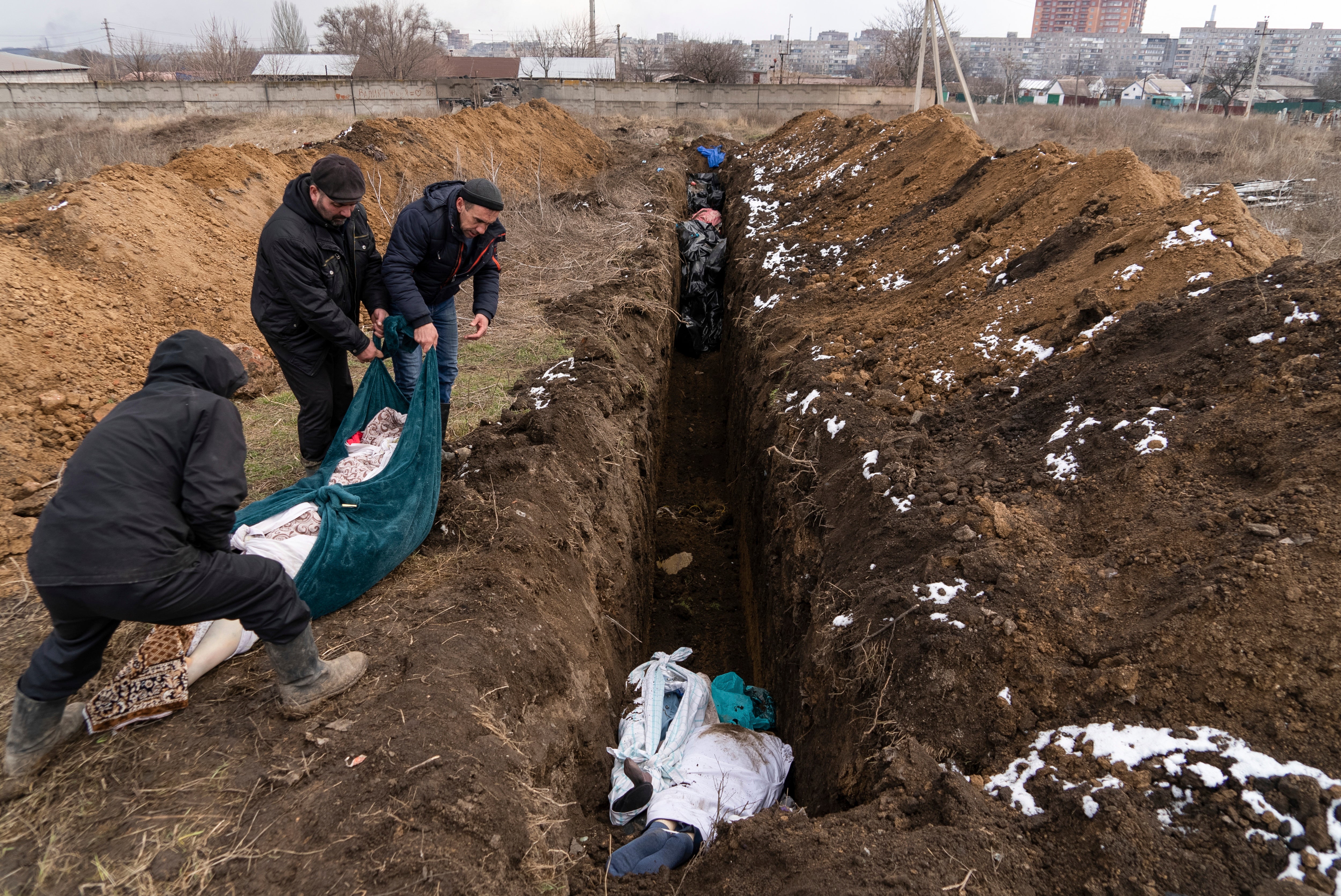 Dead bodies are buried in a mass grave in Mariupol