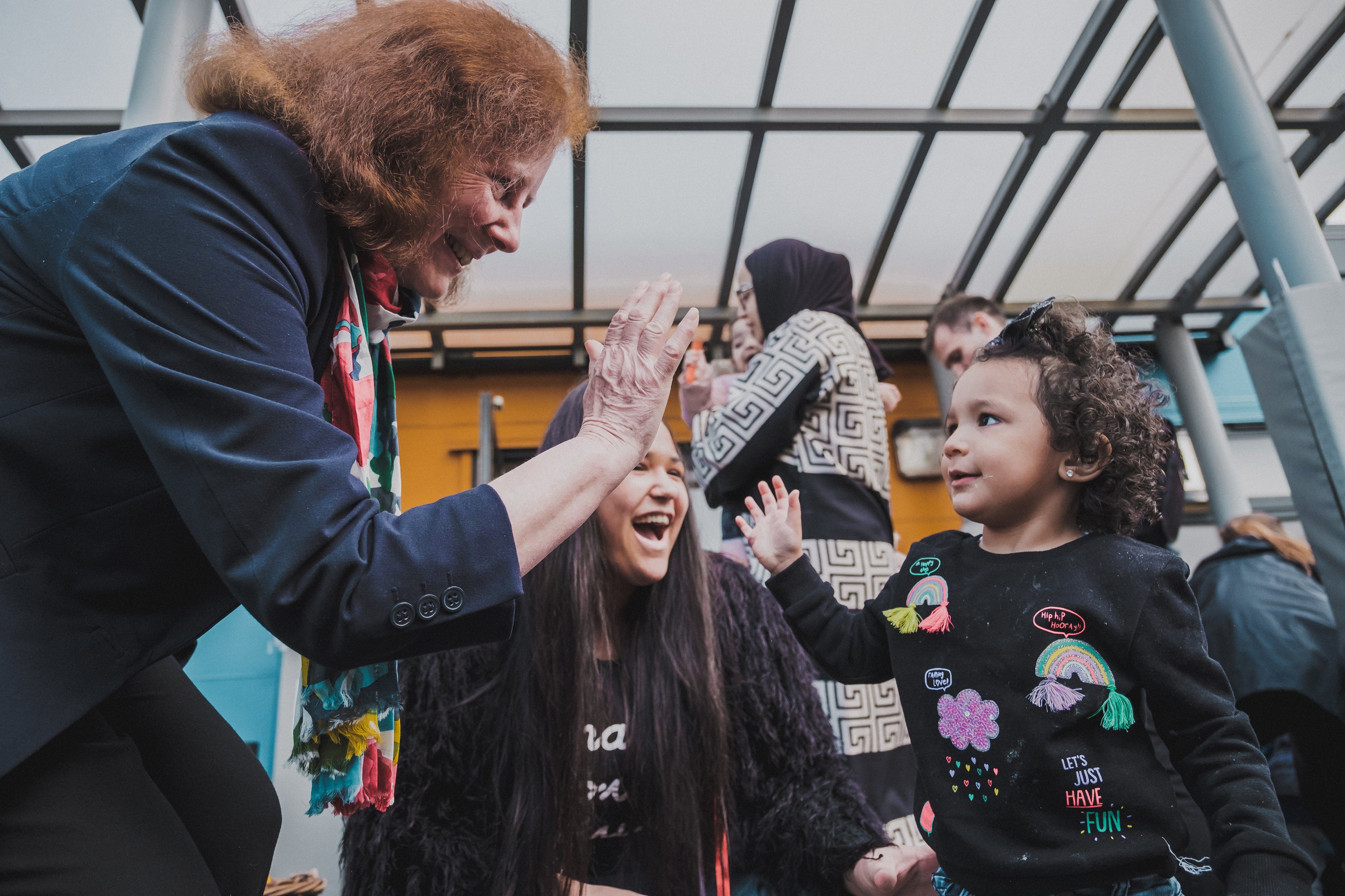 Deputy minister for social services Julie Morgan high-fives a child in celebration of the new law banning the physical punishment of children (Welsh Government handout/PA)