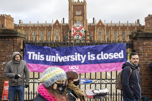 A University and College Union banner hangs off the gates of Queen’s University Belfast as staff embark on strike action (Liam McBurney/PA)