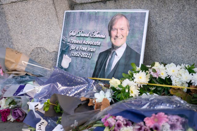Flowers left in memory of Sir David Amess outside the Houses of Parliament, in Westminster, London. Ali Harbi Ali is appearing in the dock at the Old Bailey in London, charged with the terrorism-related murder of the Southend West MP (Dominic Lipinski/PA)