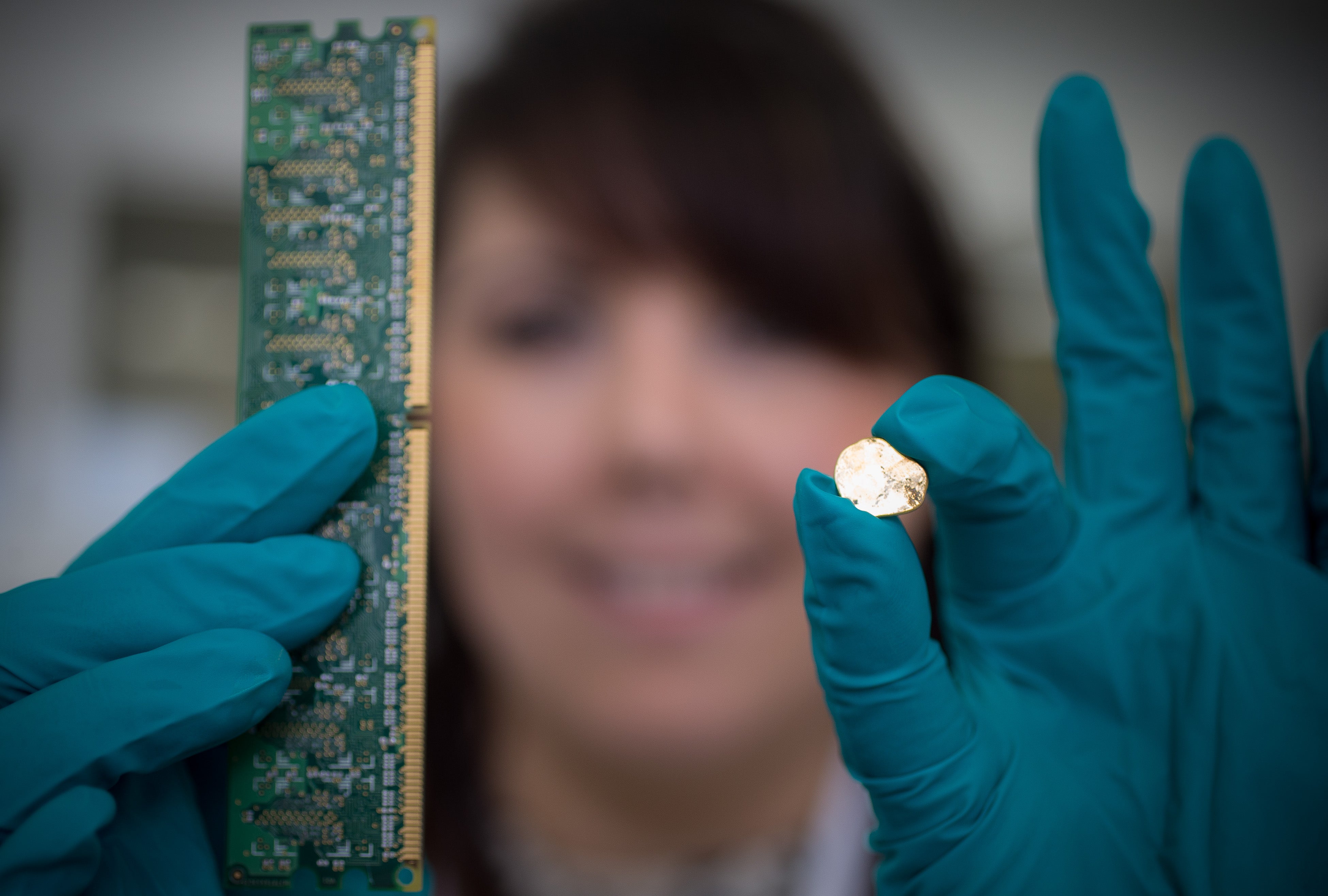 A Royal Mint employee with gold recovered from electronic waste (Royal Mint/PA)