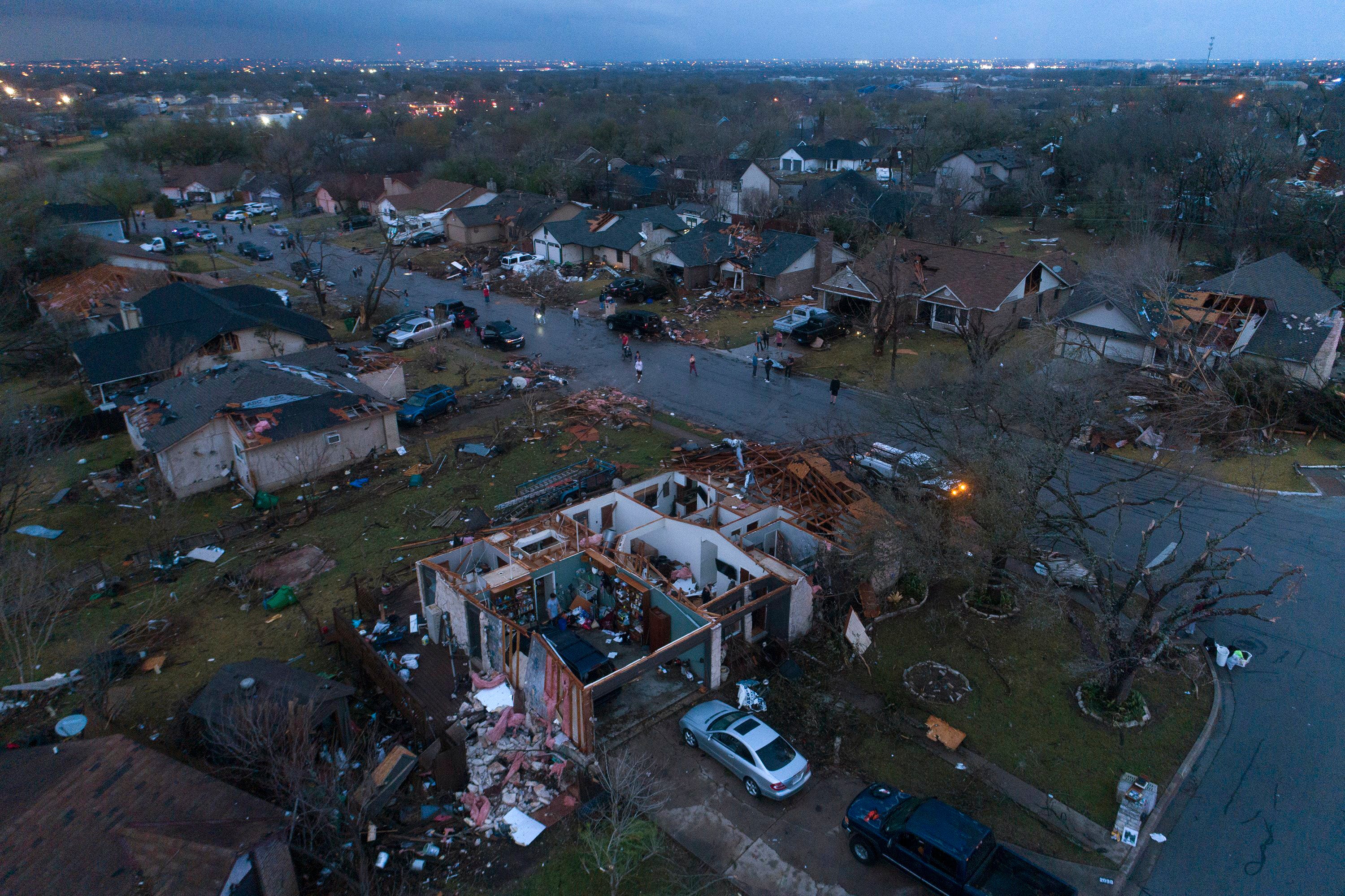 Debris litters the ground surrounding homes, damaged by a tornado, on Oxford Drive and Stratford Drive in Round Rock