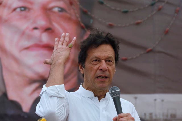 <p>Imran Khan, chairman of the Pakistan Tehreek-e-Insaf (PTI), addresses his supporters during a campaign rally </p>