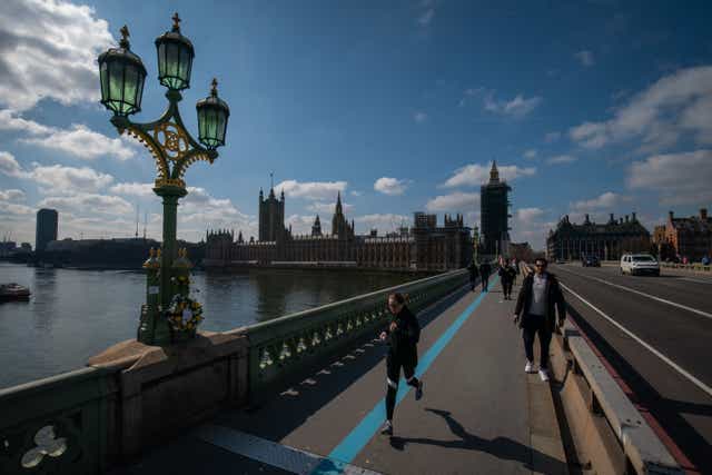 People walk along Westminster Bridge in London (Aaron Chown/PA)