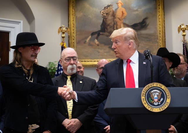 <p>US President Donald Trump shakes hands with musician Kid Rock (L) prior to signing the Hatch-Goodlatte Music Modernization Act, a bipartisan bill aimed at ensuring artists who released records prior to 1972 are paid royalties from digital services, in the Roosevelt Room of the White House in Washington, DC, October 11, 2018</p>