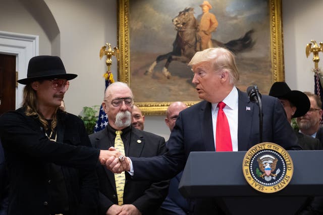 <p>US President Donald Trump shakes hands with musician Kid Rock (L) prior to signing the Hatch-Goodlatte Music Modernization Act, a bipartisan bill aimed at ensuring artists who released records prior to 1972 are paid royalties from digital services, in the Roosevelt Room of the White House in Washington, DC, October 11, 2018</p>