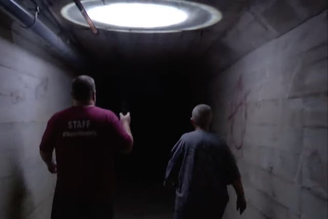 <p>Tour organisers inside the ‘dead body chute’ at Waverly Hills, outside Louisville </p>