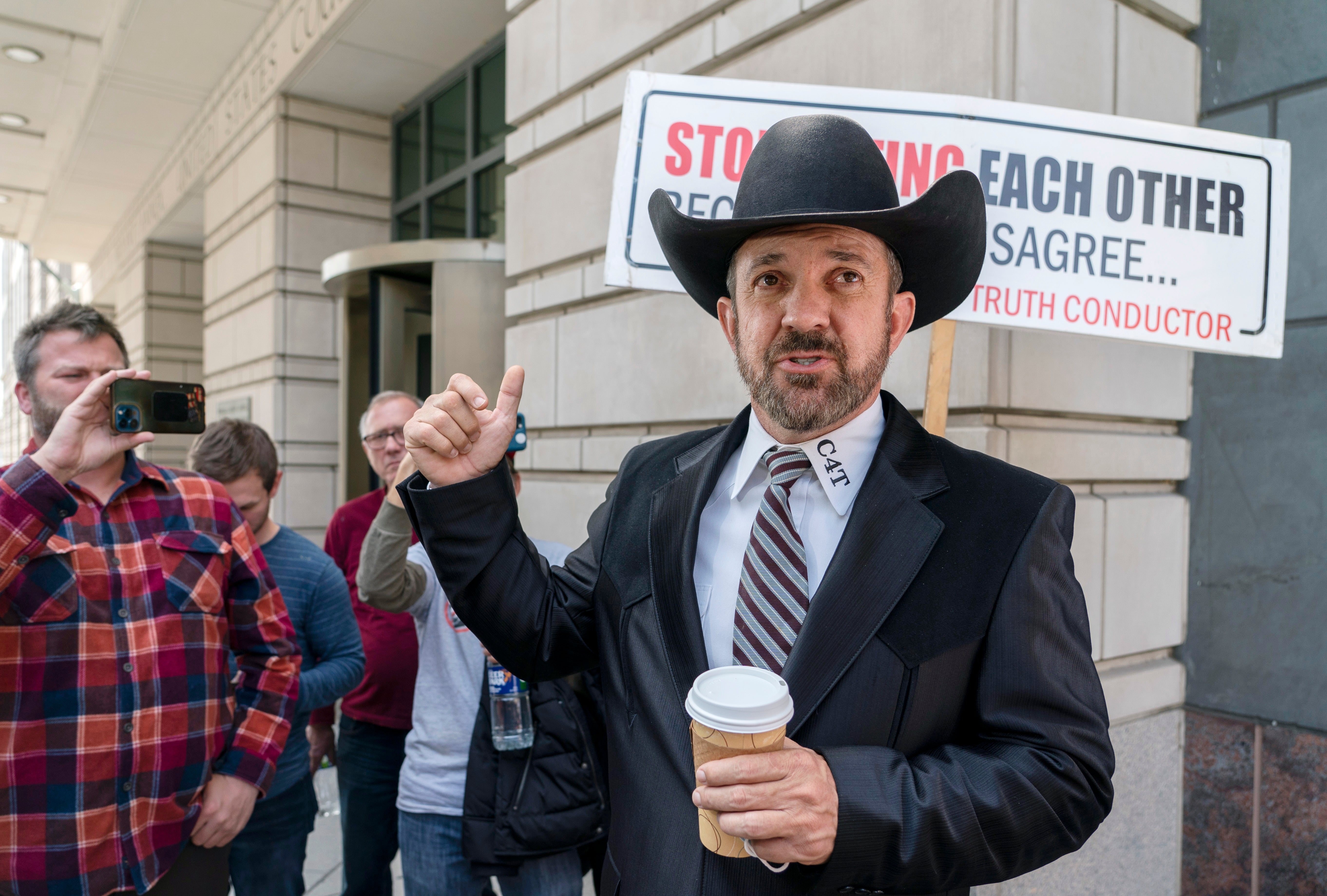 Otero County, New Mexico Commissioner Couy Griffin gestures as he speaks outside federal court after receiving a guilty verdict in his trial