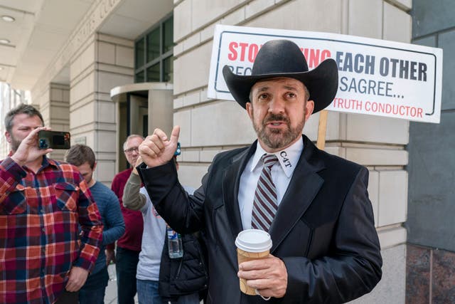 <p>Otero County, New Mexico Commissioner Couy Griffin gestures as he speaks outside federal court after receiving a guilty verdict in his trial</p>