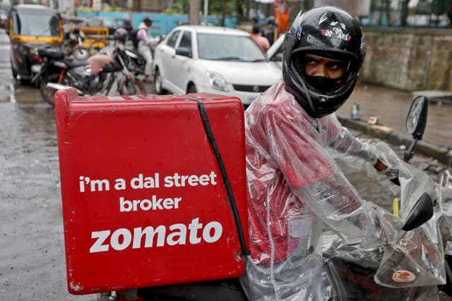 <p>A delivery worker of Zomato, an Indian food-delivery startup, prepares to leave to pick up an order from a restaurant in Mumbai,</p>