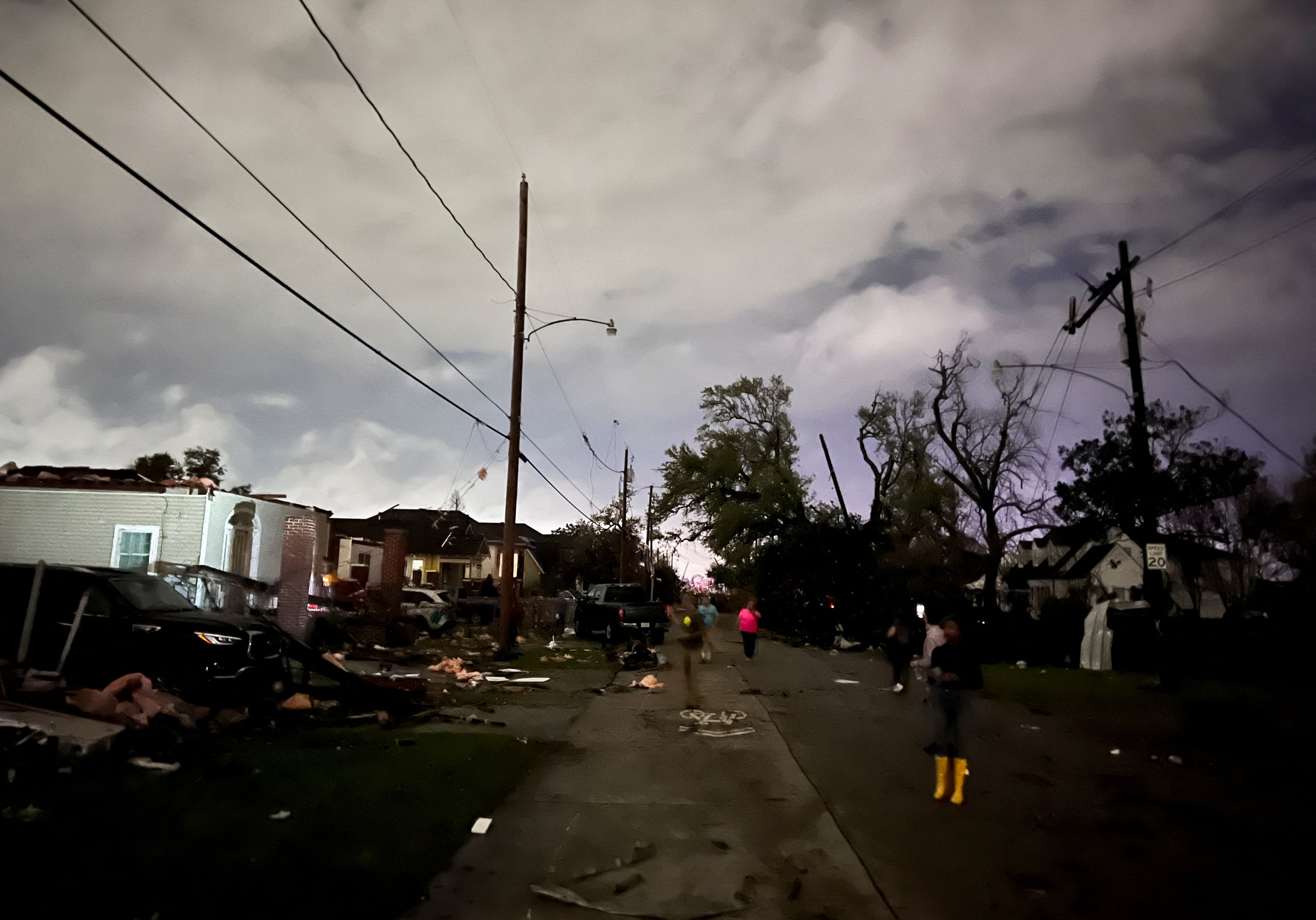 People view damage to buildings in the Arabi neighborhood after a large tornado struck New Orleans on Tuesday