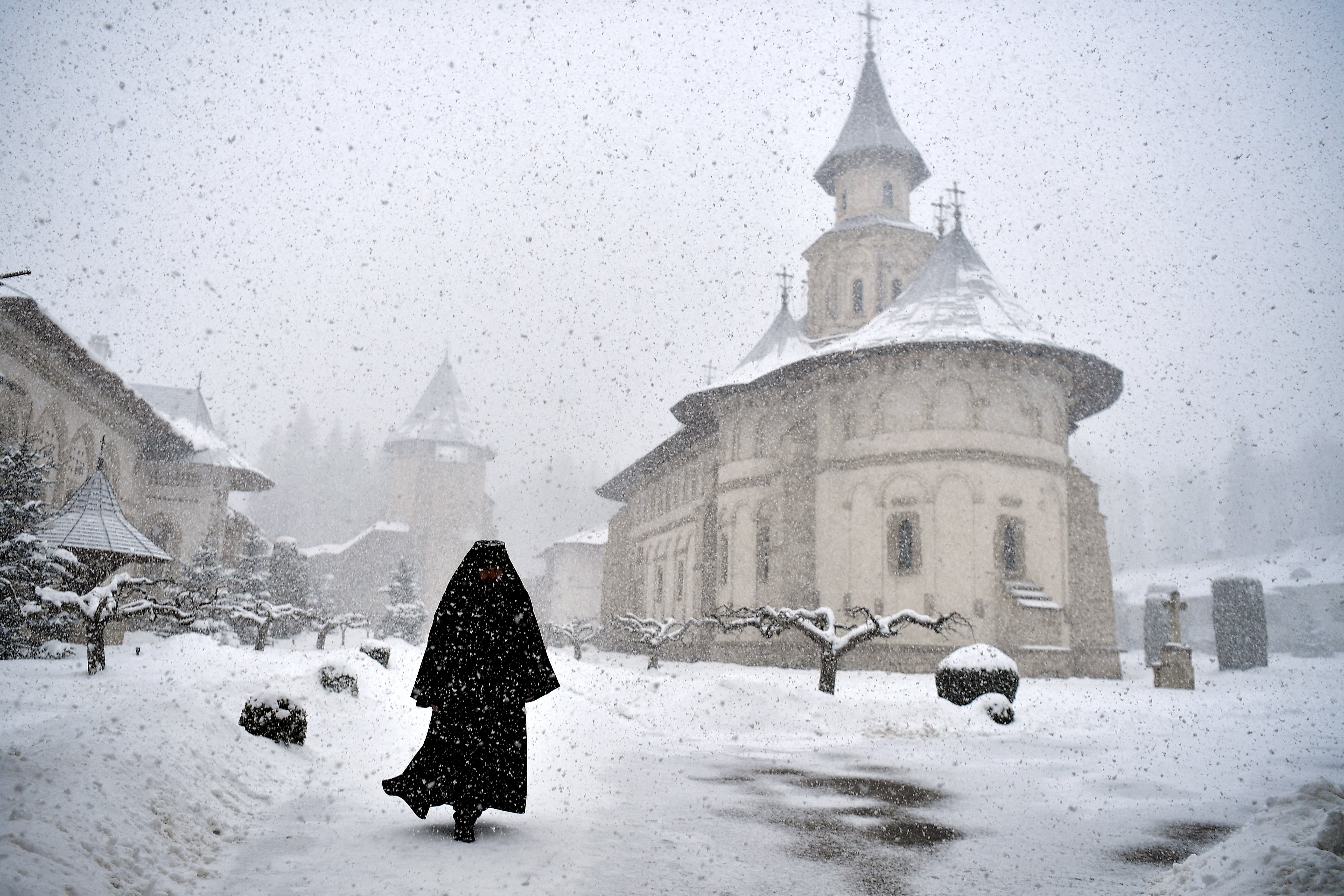 Romanian Orthodox monk Father Mikhail departs after mass at the church in Putna monastery, Romania