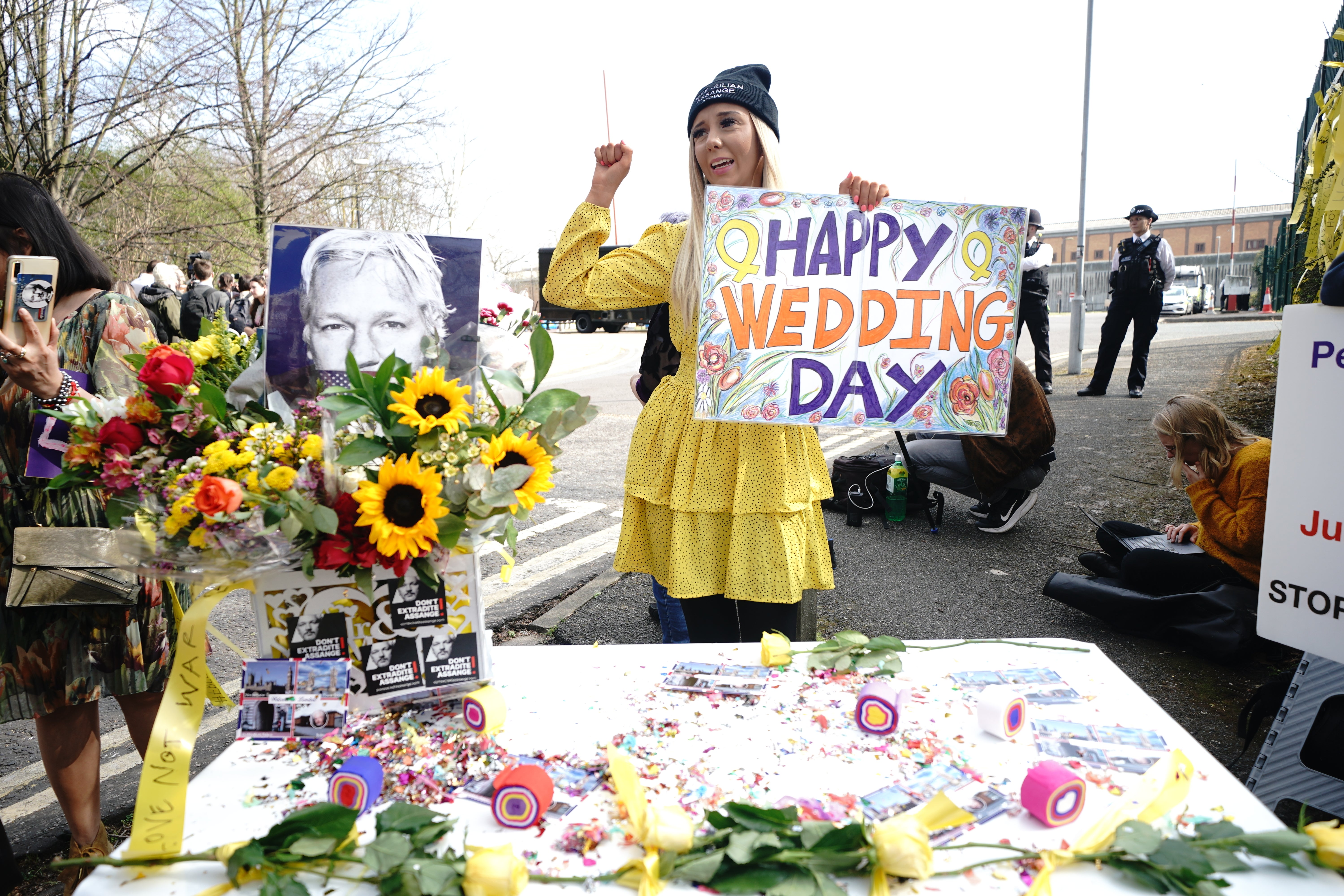 Wellwishers celebrate the wedding outside (Yui Mok/PA)