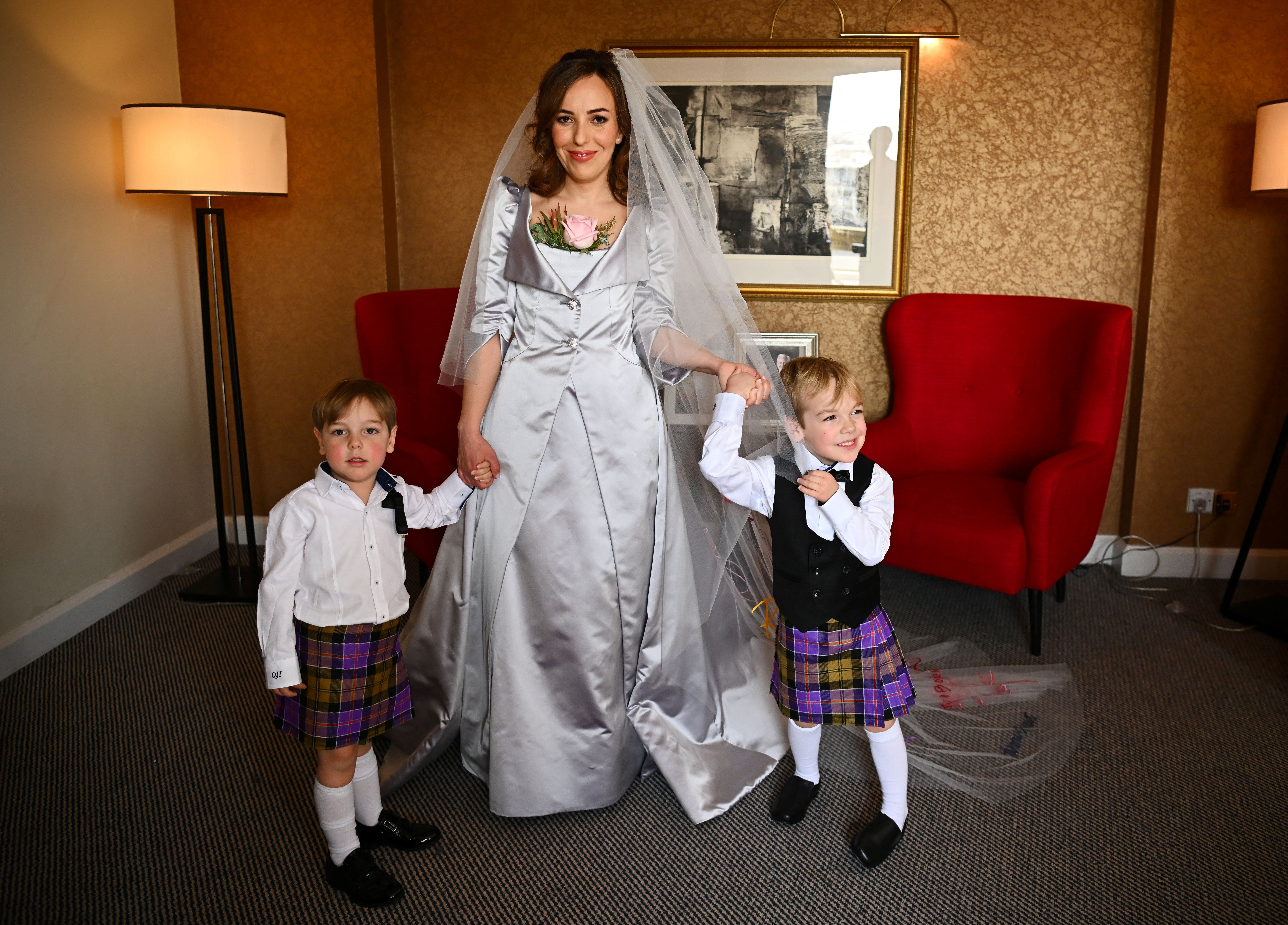 Stella Moris, the partner of Wikileaks founder Julian Assange, is photographed in her Vivienne Westwood designed wedding dress, with their sons Max, three, and Gabriel, four, at a hotel in London, ahead of the wedding ceremony (Dylan Martinez/PA)