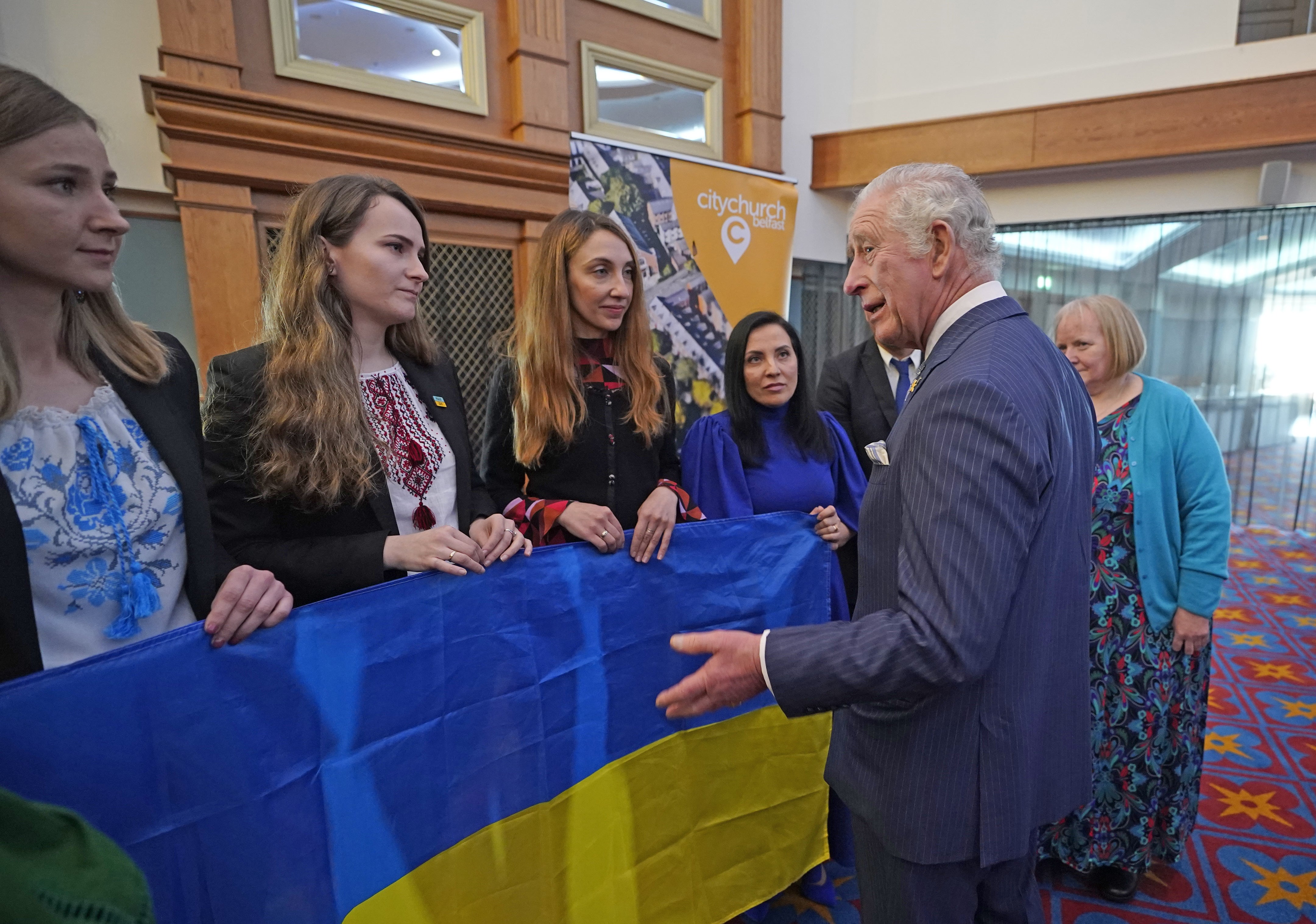 The Prince of Wales meets Ukrainian women (left-right) Iuliia Wilson, Kateryna Zaichyk, Maryna Opanasenko and Alina Bilous during a reception at Titanic Belfast (Niall Carson/PA)