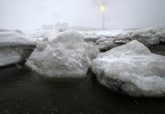 <p>Gas flares off under heavy snowfall at a liquefied natural gas (LNG) plant on Sakhalin island outside the town Korsakov, Russia </p>