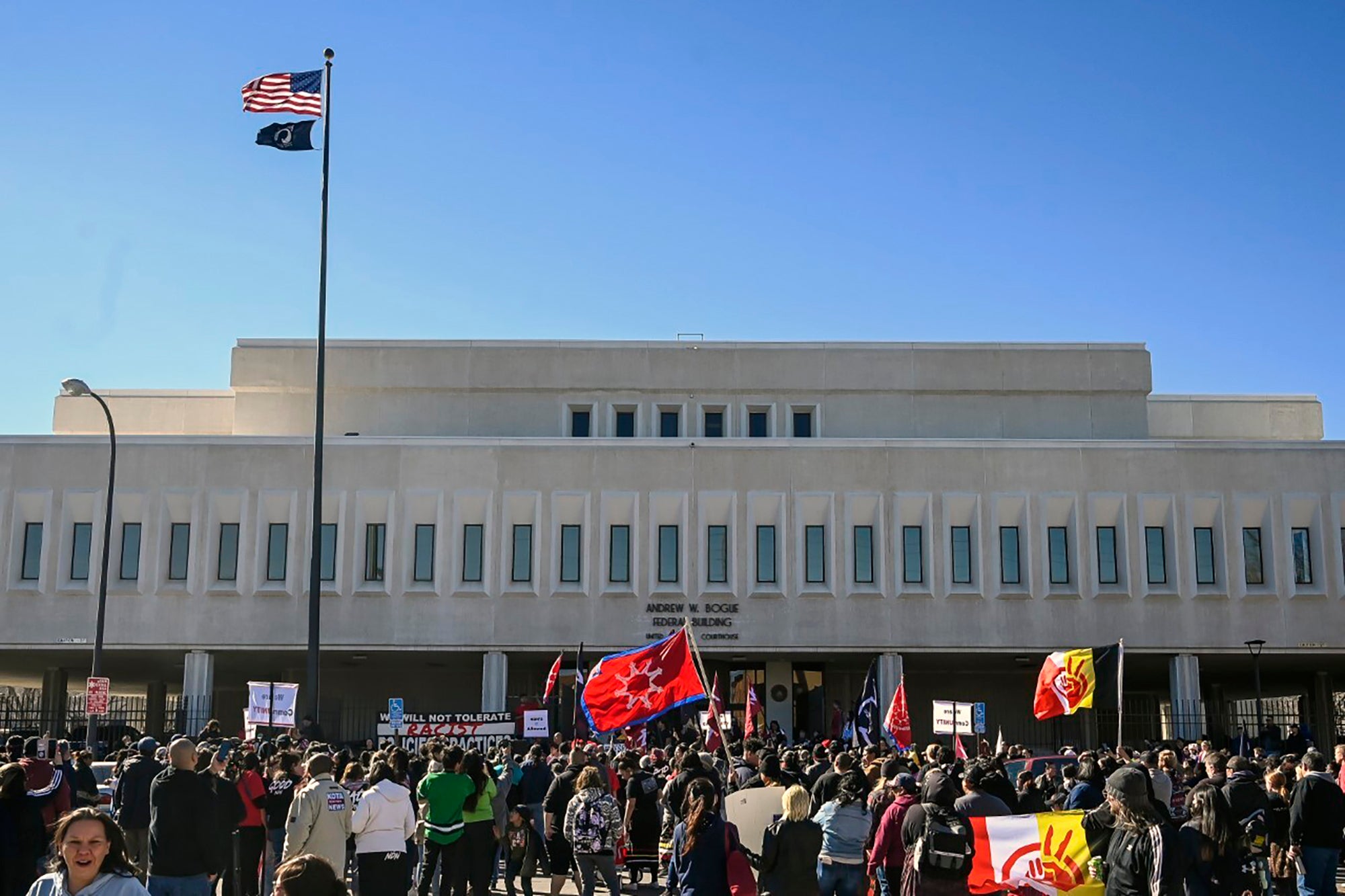 Demonstrators gather outside the Andrew W. Bogue Federal building on Wednesday, March 23, 2022, in Rapid City, where it was announced that a federal civil rights lawsuit was filed against the Grand Gateway Hotel for denying services to Native Americans