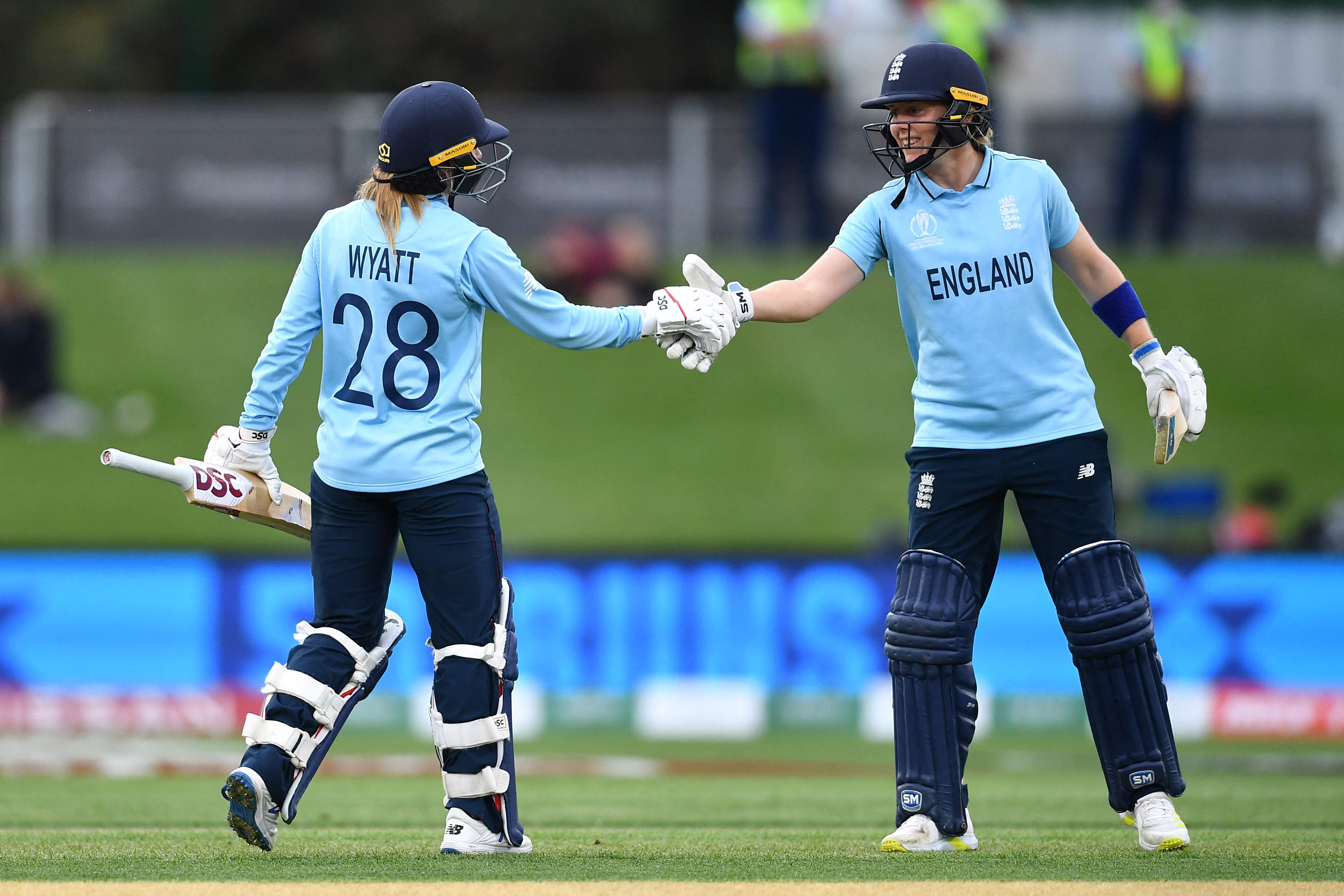England's Danni Wyatt, left, is congratulated by team captain Heather Knight after scoring a half century
