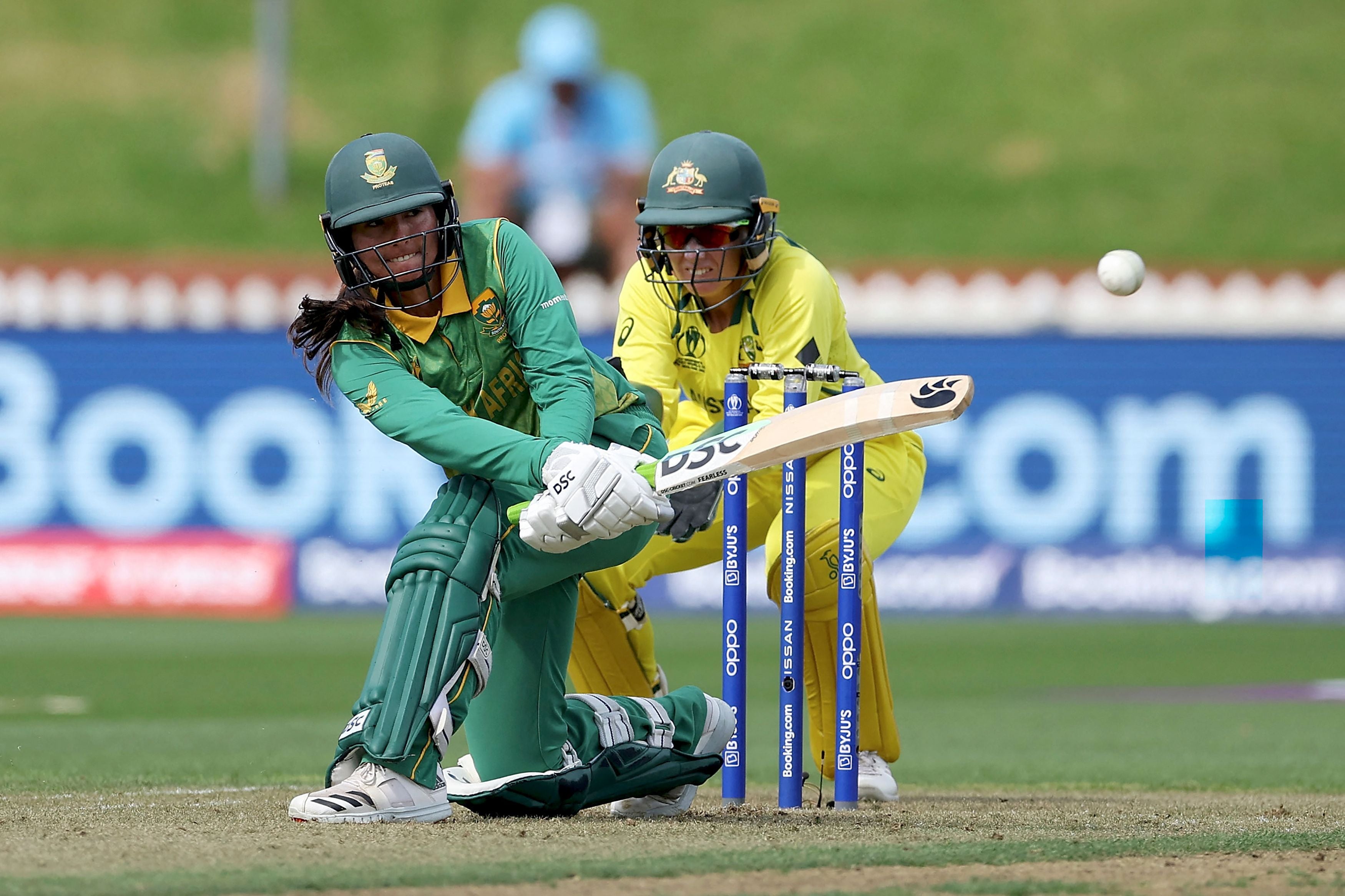 South Africa captain Sune Luus plays a shot watched by the Australia wicketkeeper Alyssa Healy