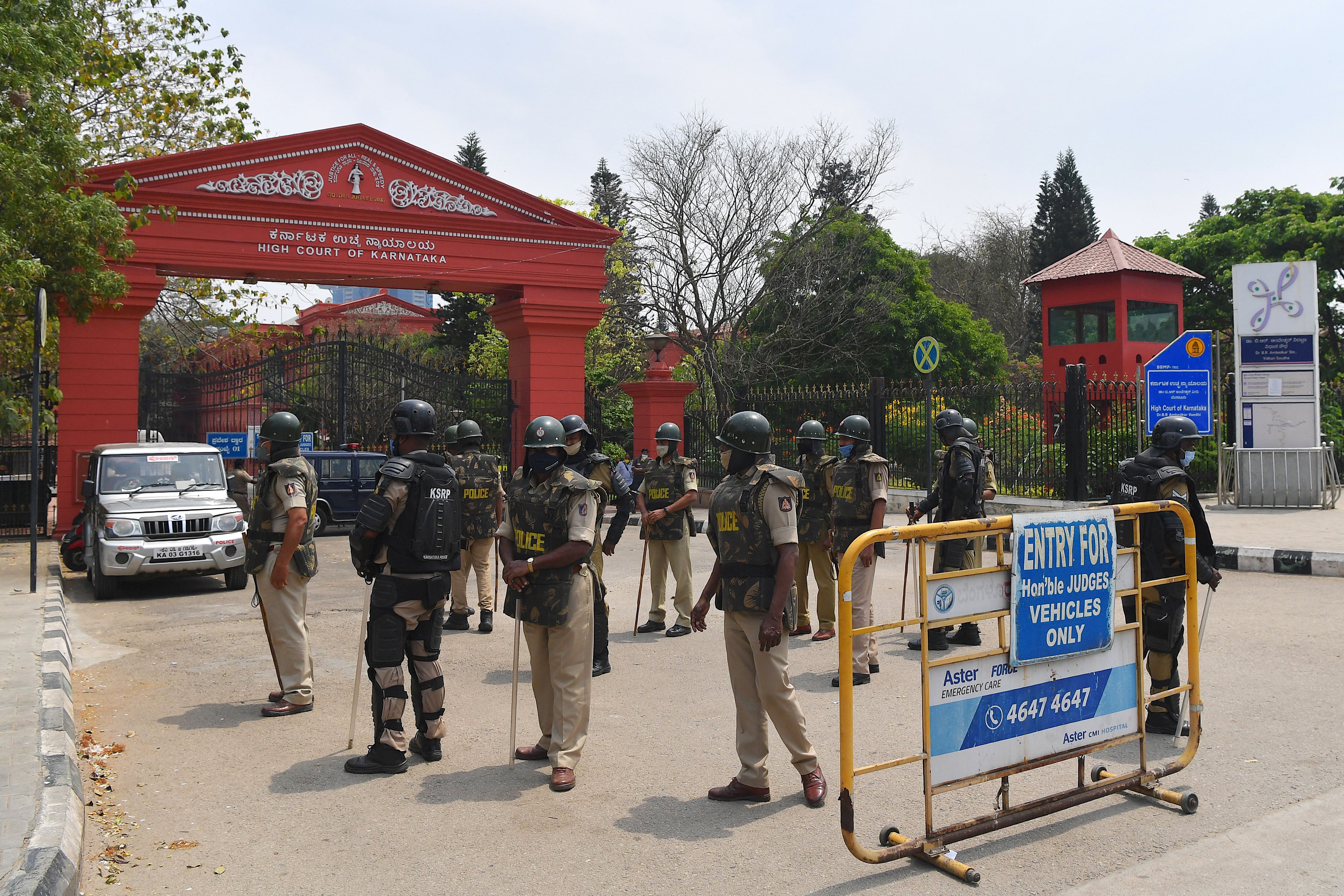 Police personnel stand in front of the Karnataka High Court in Bangalore