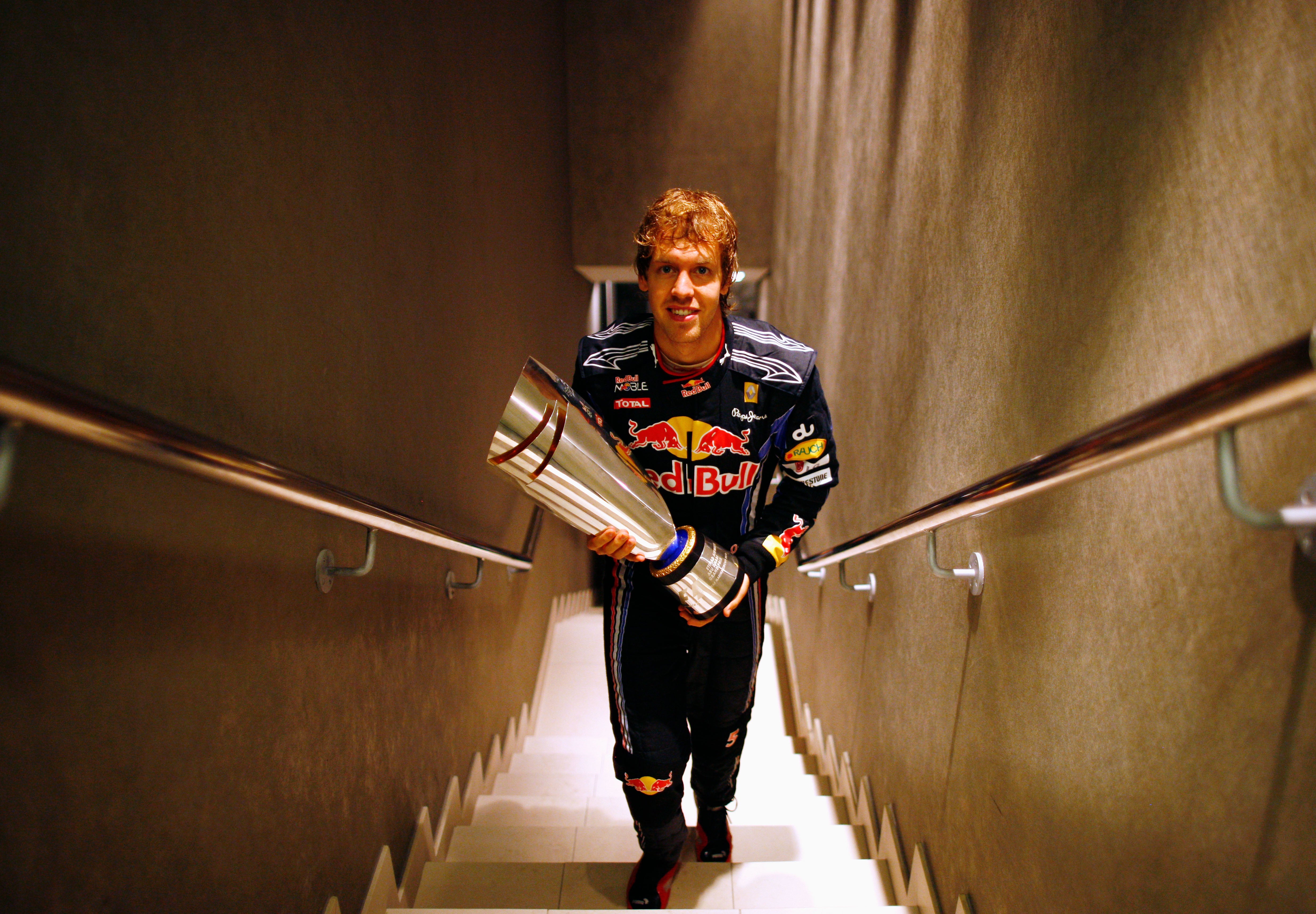 Vettel carries his trophy after winning the 2010 world title in Abu Dhabi – his first of four