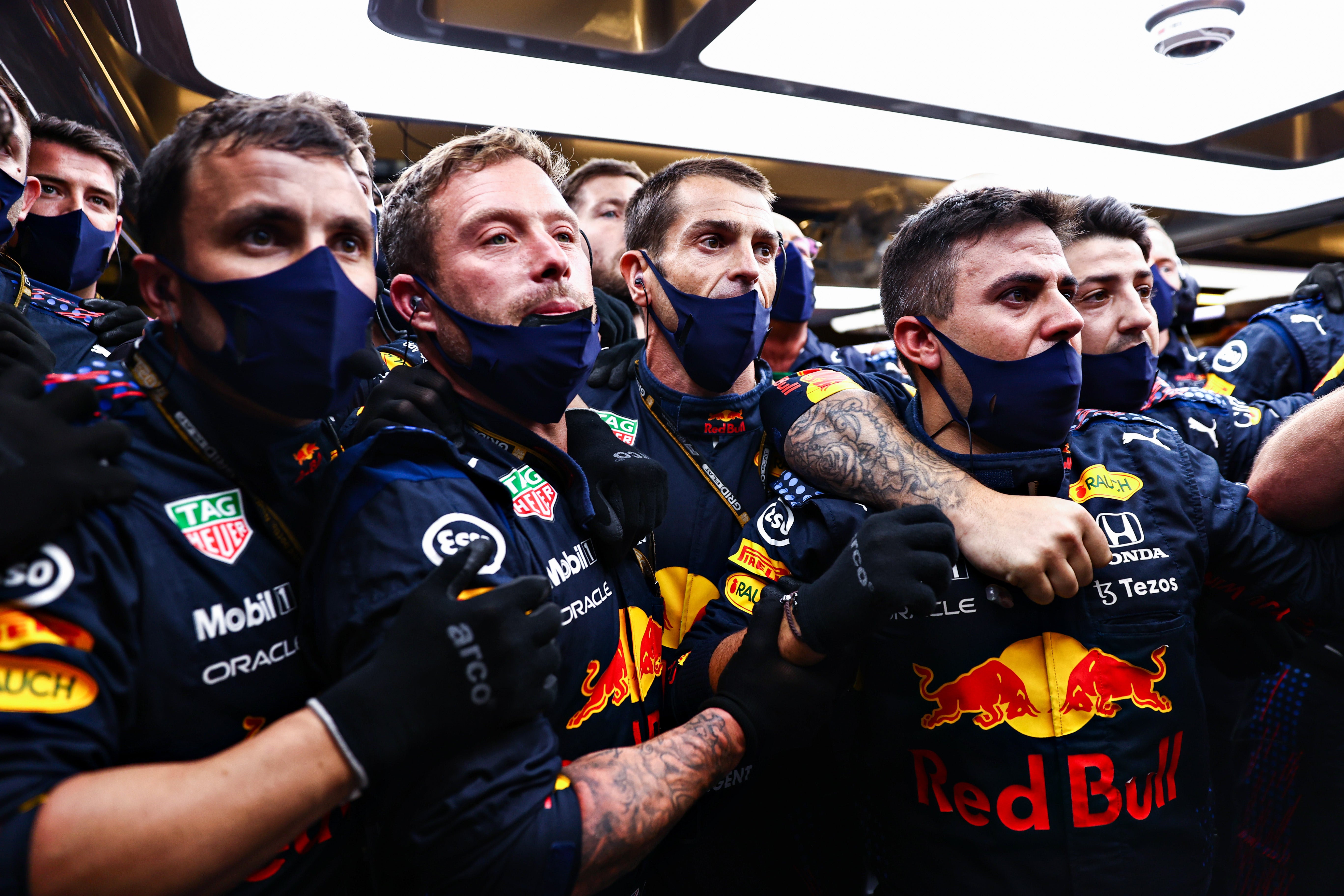 Red Bull mechanics watch the tense finale from the garage...