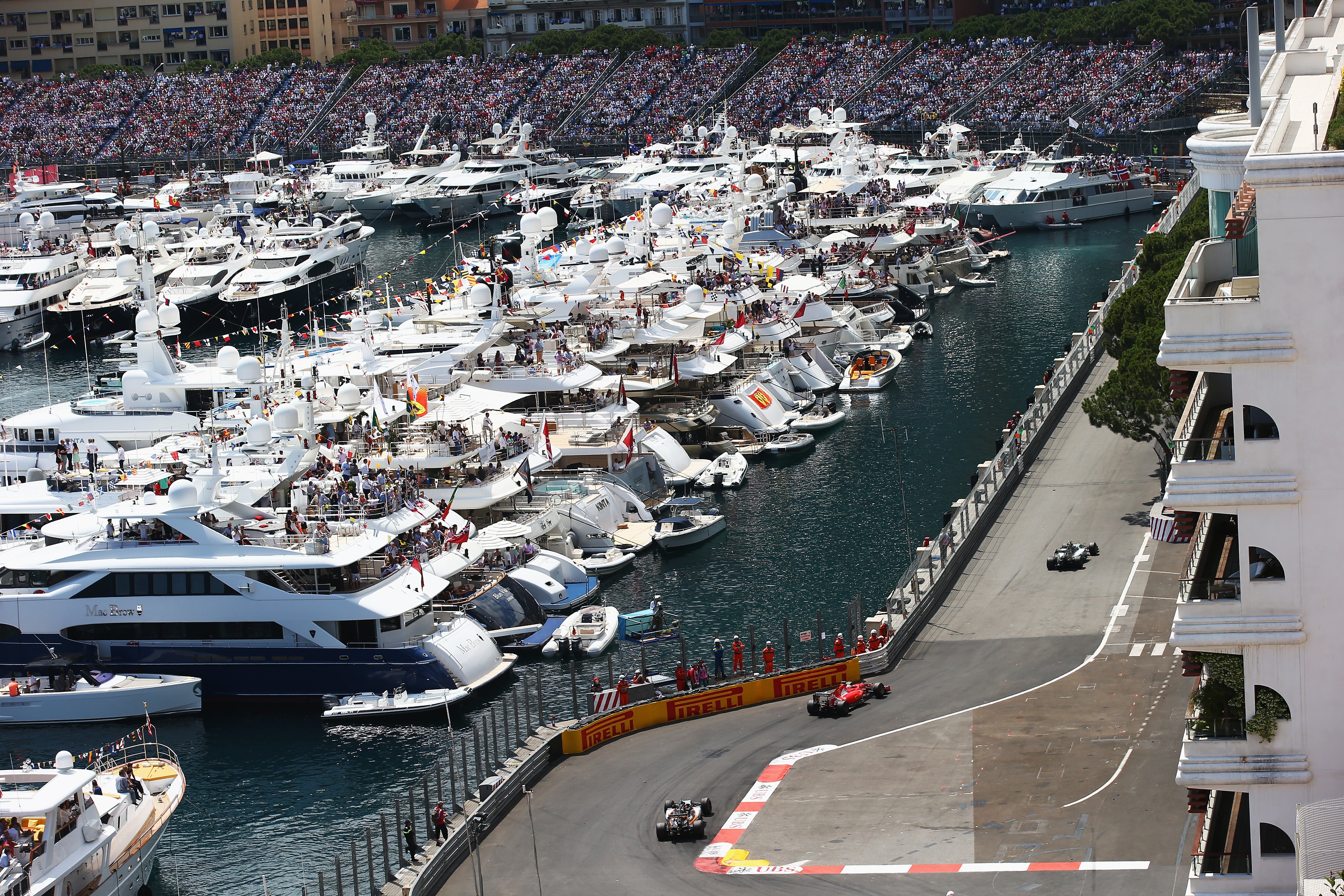 Fans watch from the Monaco Grand Prix from the marina